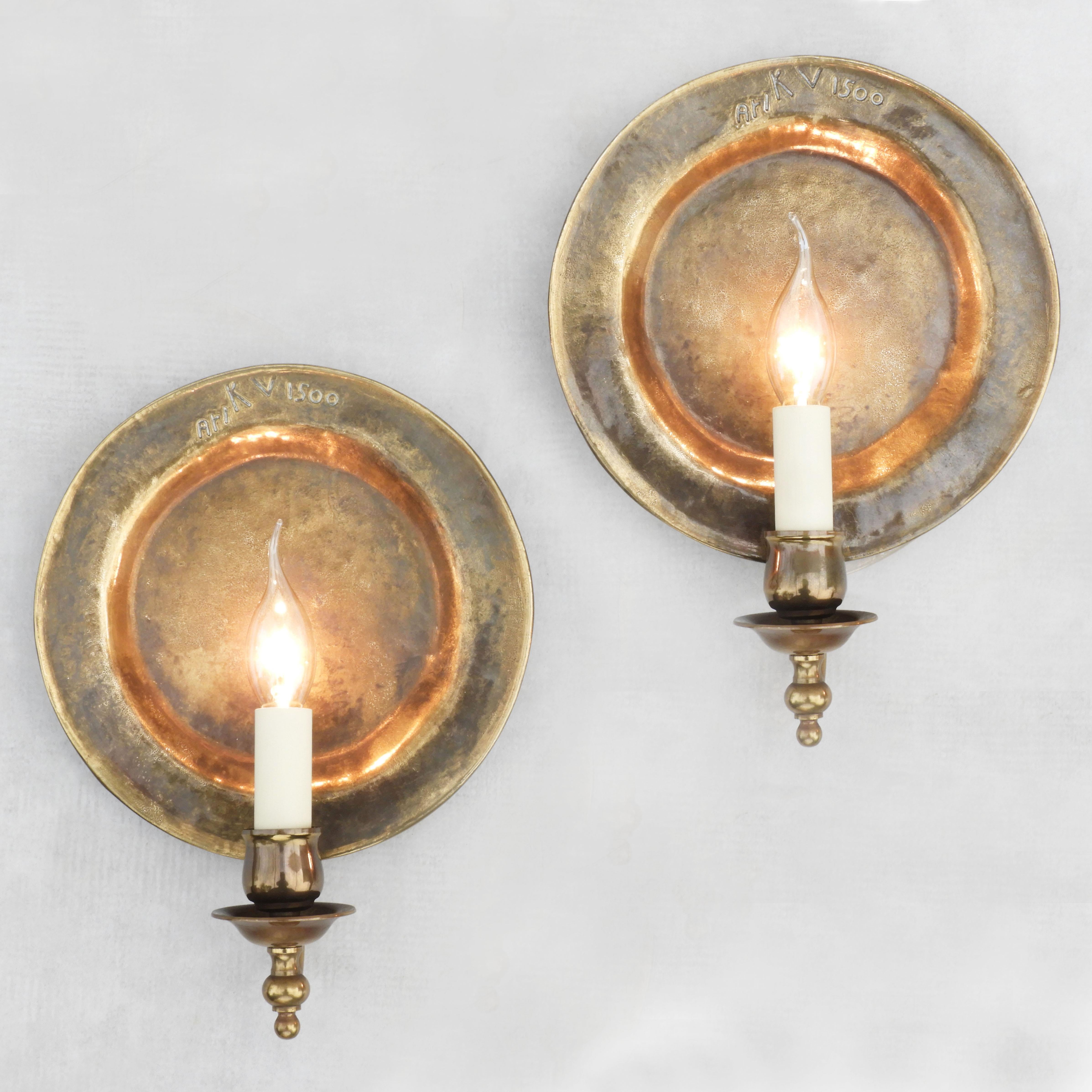 Vintage pair of stylish French bronze wall plate sconces C1970. 
Convex textured solid bronze round 'moon' back plates that reflect a beautiful warm glow from each of the single faux candle lights.  In great vintage condition with good patina. Each