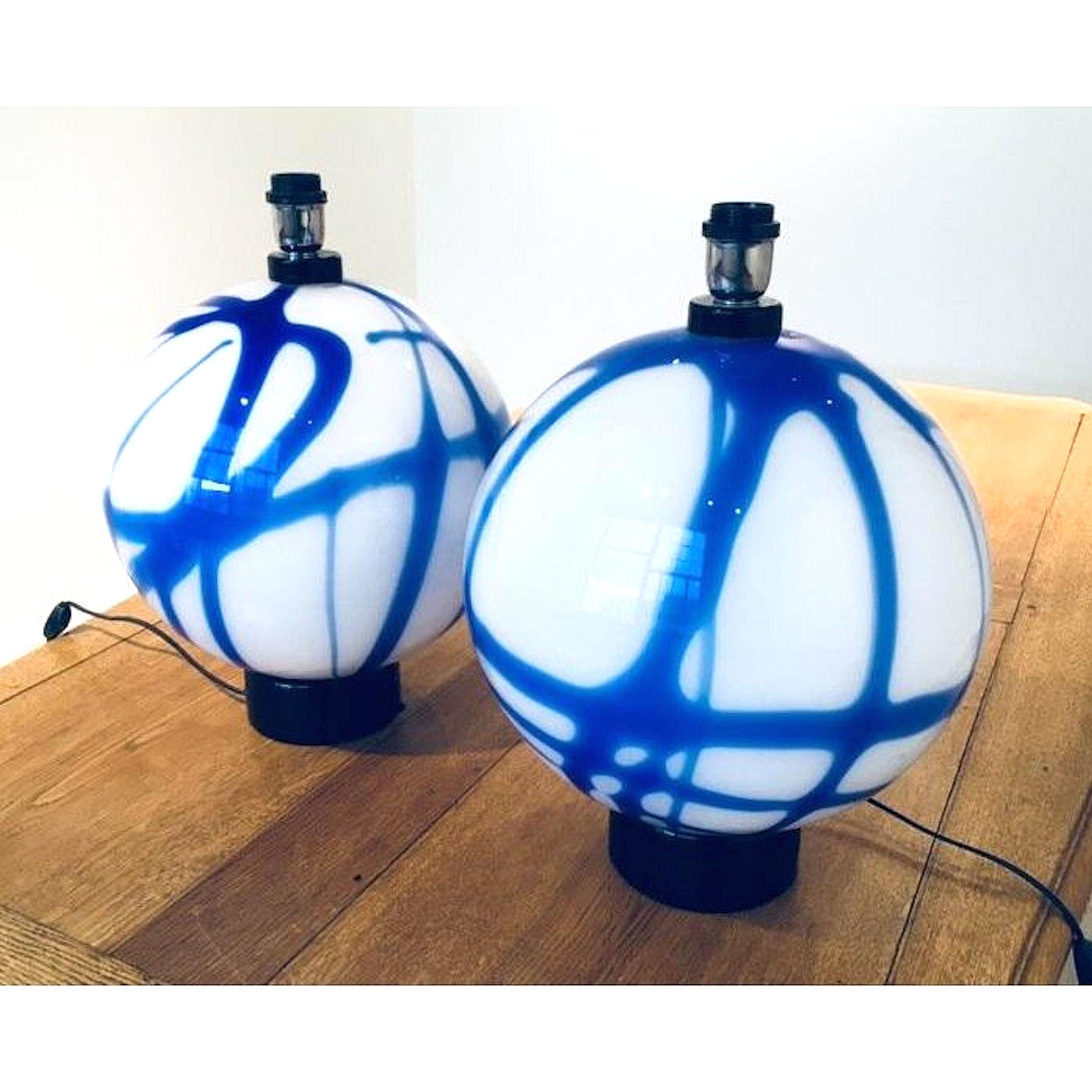Mid-Century Modern Italian table lamps comprised of blue and milk Murano glass, Carlo Nason style. 
Hand painted/colored glass, with black opaque glass base.
Newly wired,  
Italy, Murano, circa 1960s.
Sold without shades.