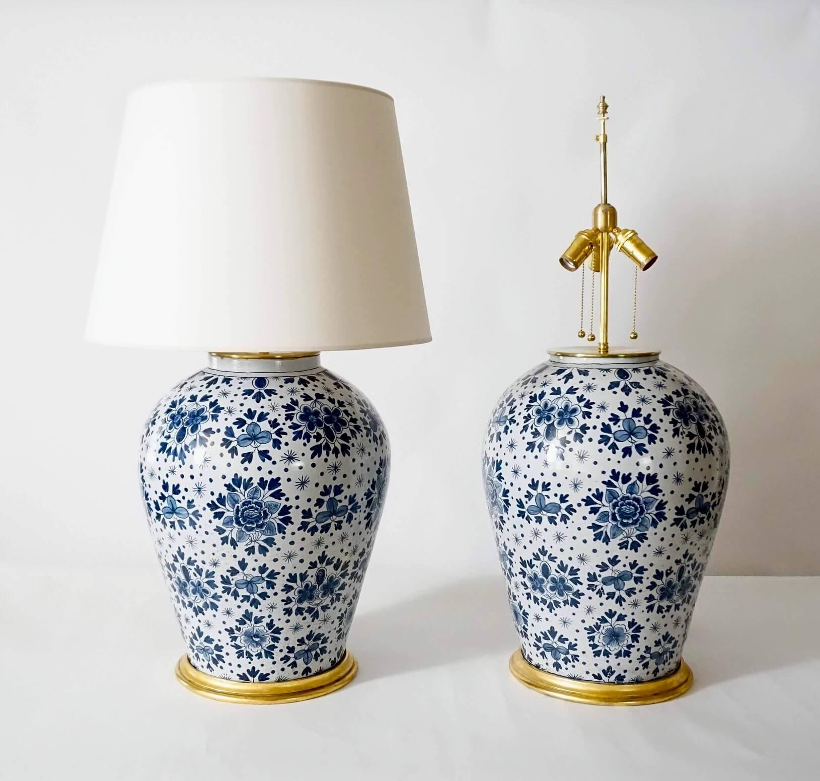 A wonderful, rare, and massively scaled pair of mid-19th century blue-and-white Dutch Delft pottery jar table lamps attributed to the Makkum factory, the thickly potted baluster form vases having allover 'blossom-and-star' pattern painted in blue on