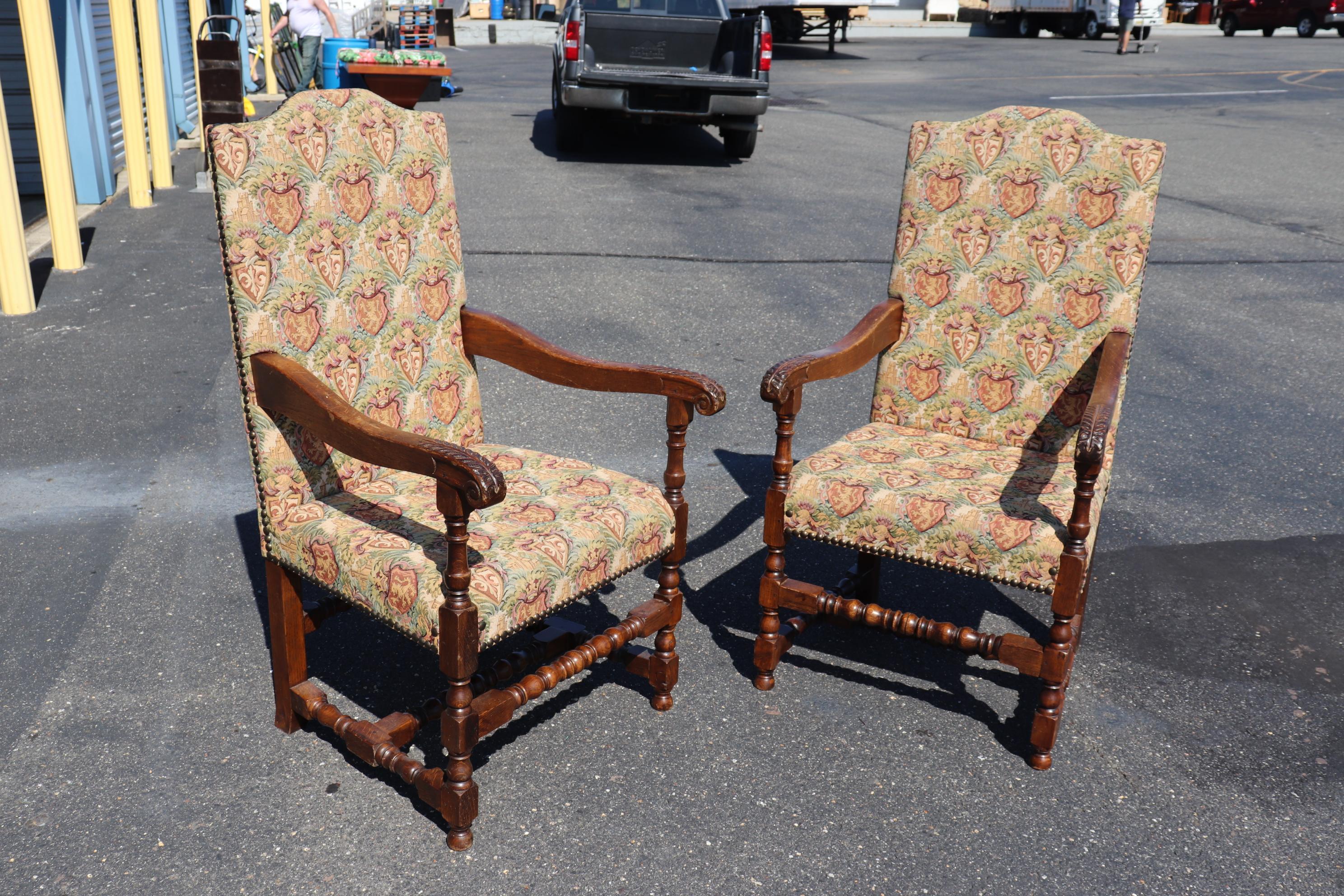 This is a gorgeous pair of carved oak heavy throne or dining head chairs. The chairs are in very good condition with beautiful machine-made tapestry upholstery and great solid frames and good carving. The chairs measure 48 tall x 26 wide x 30 deep