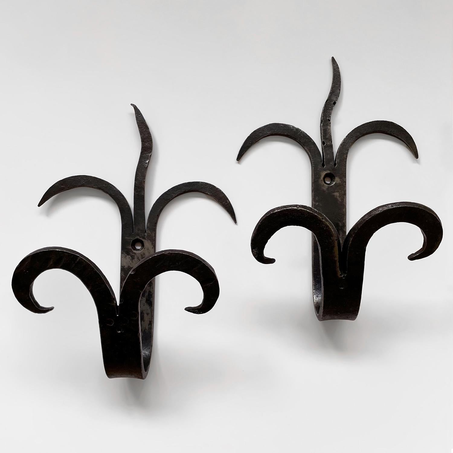 Pair of French forged iron double wall hooks
France, early 20th century
These beautifully sculpted wall hooks are a dramatic statement piece for an entry
Each hook is slightly unique in its composition
Whimsical double arched lower hooks provide two