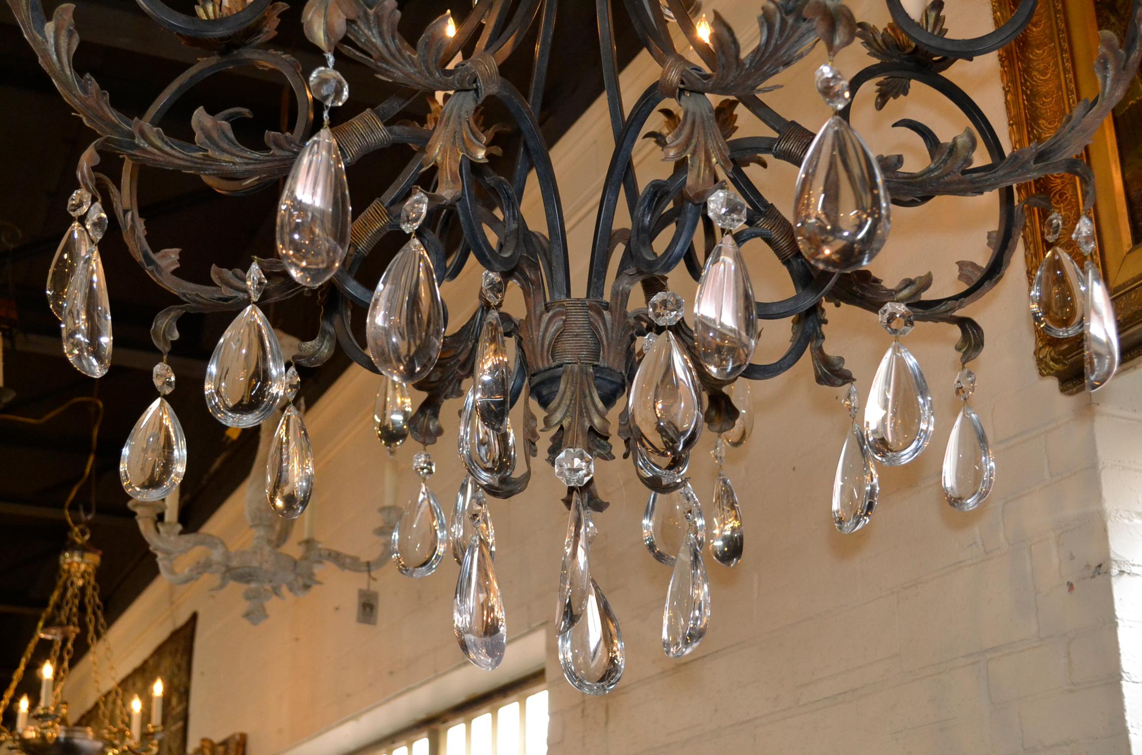 Impressive pair of large scale French style iron and crystal chandeliers.