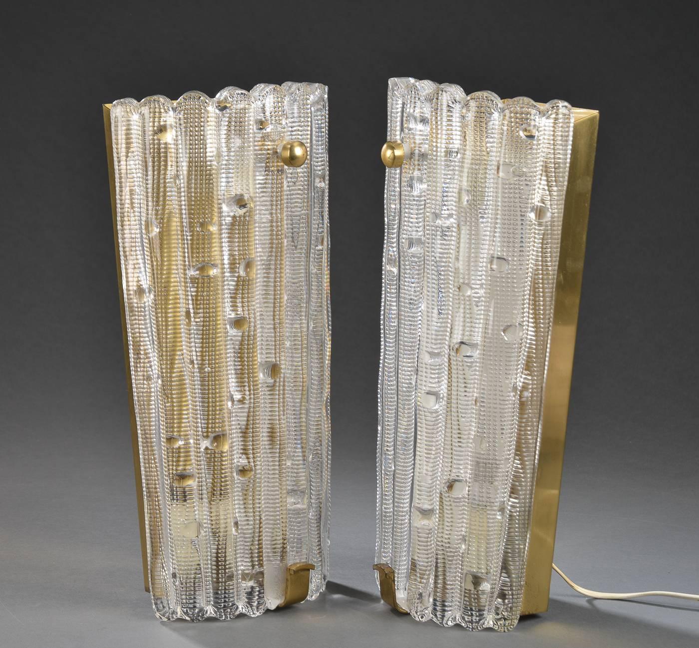 Pair of large-scale sconces of pressed glass and brass wall sconces designed by Carl Fagerlund for Orrefors of Sweden, circa 1950s-1960s.