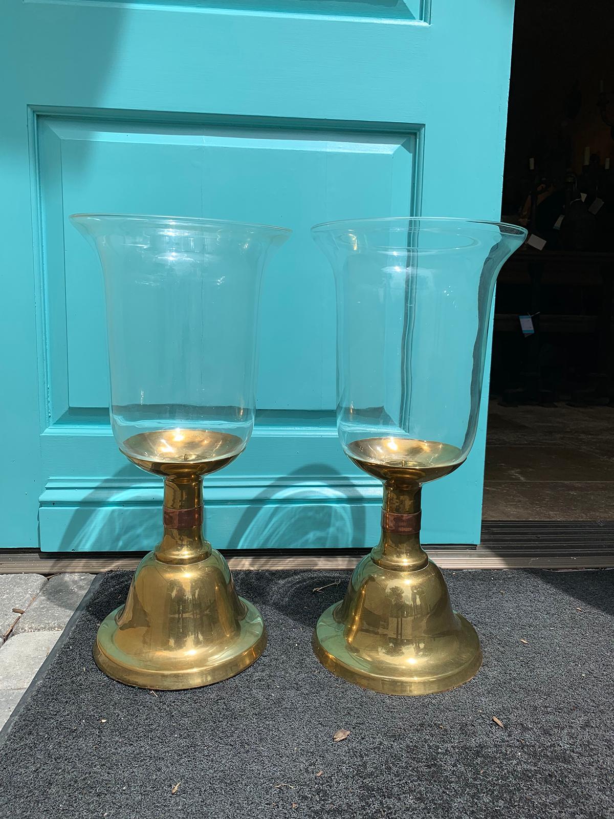 Pair of large scale Sarreid brass candlesticks with hurricane, circa 1980s
Single copper-toned banding on brass candlesticks
Glass hurricanes are clear. Turquoise shown is of our front door
Measures: 10.5
