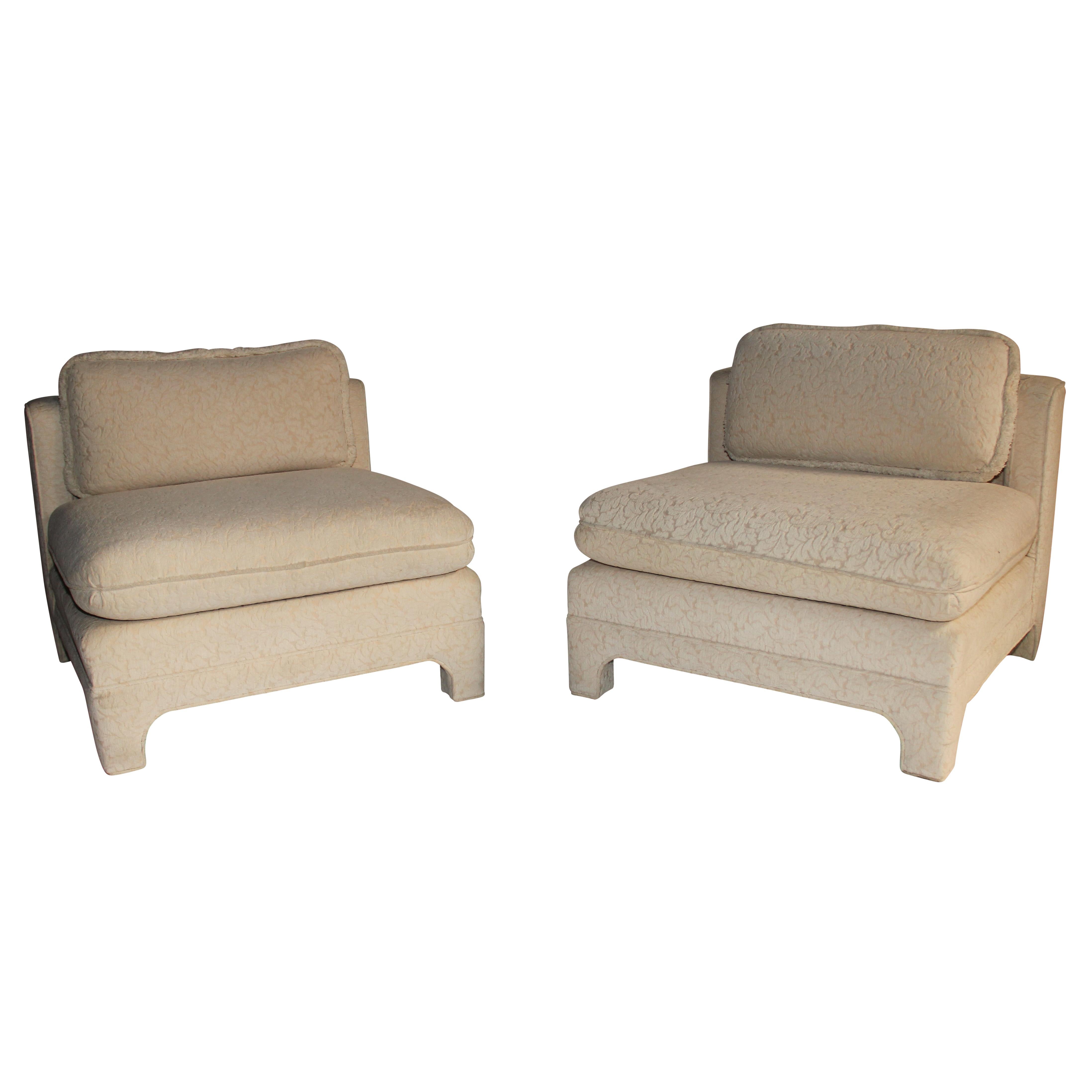 These large and comfortable chairs are fully upholstered and feature clean lines and just the right amount of detail, including arched feet and a notched back that accommodates a single loose cushion. Beautifully made by Interior Crafts of Chicago,