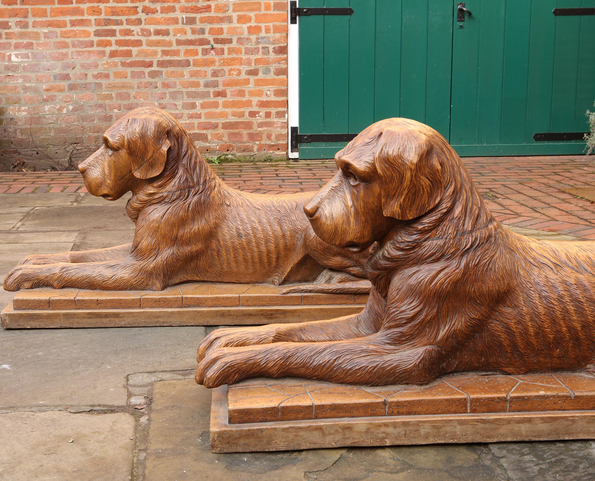 Pair of Large Scale Swiss Black Forest Carved Couchant Hunting Dogs In Good Condition For Sale In London, by appointment only