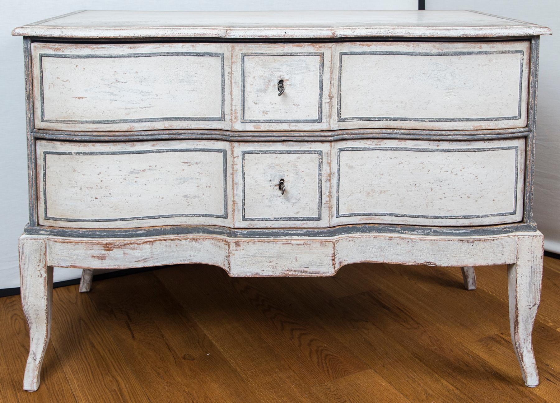 Lovely pair of large decorative baroque chests painted in an off white color with grey-blue detailing, comprised of two long drawers and finishing on high modified cabriole legs
Dating: circa 20th century with antique parts taken from an early circa