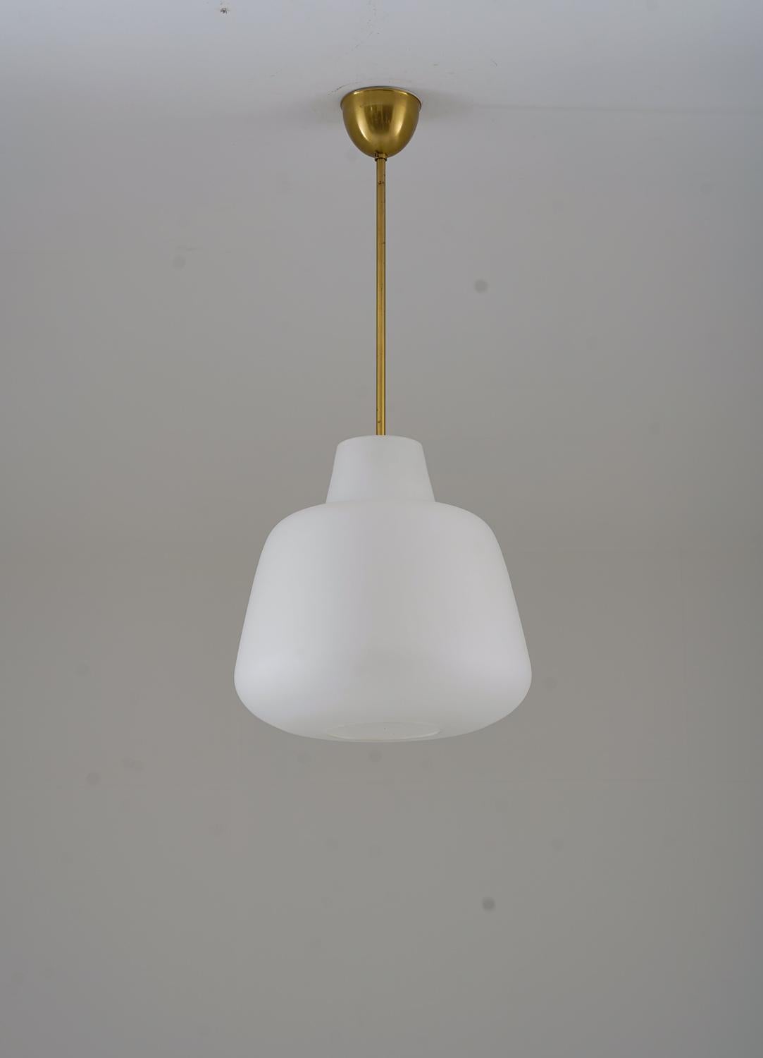 Majestic and beautifully shaped pendants in brass and frosted glass, produced by ASEA in Sweden circa 1940. 
The frosted glass gives a beautiful and soft light. 

Condition: Good original condition.