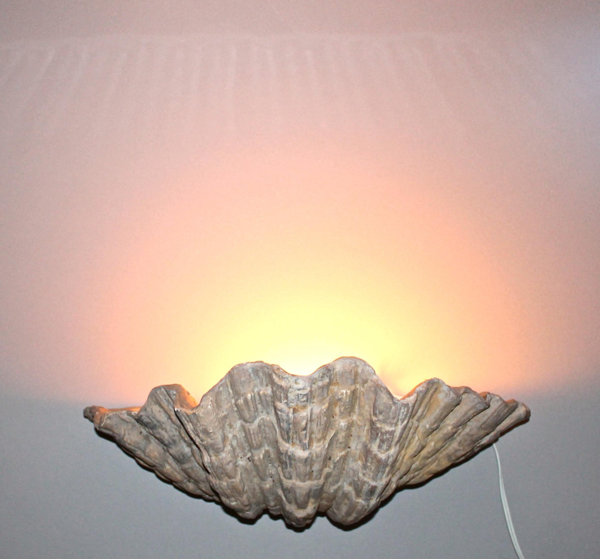 Designed and made by Serge Roche, a very large pair of period cast plaster wall sconces. Original patination. Measures: H 8