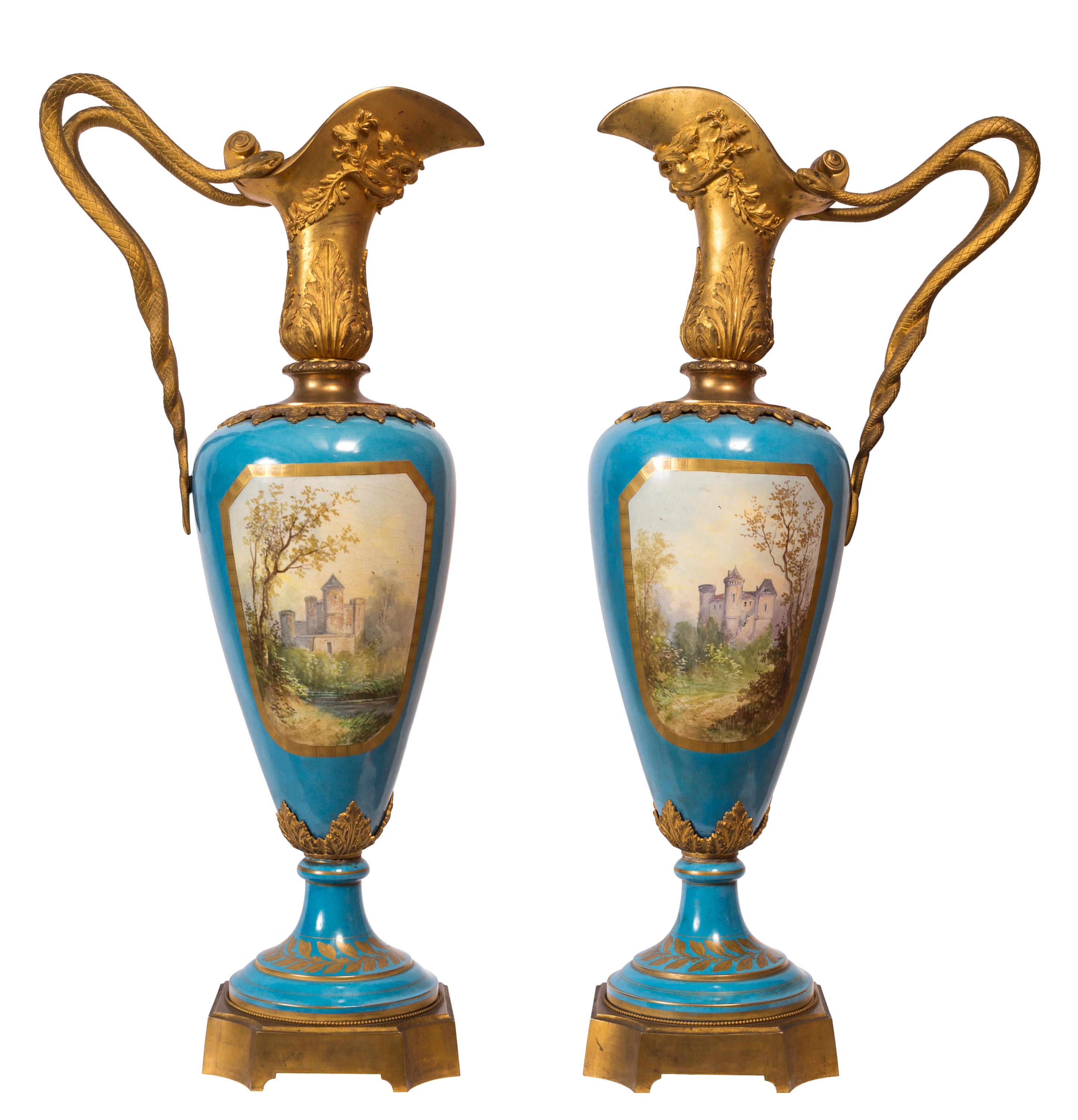 Impressive in size (1 meter / 3.28 feet), this striking pair of 19th century Sèvres style porcelain ewers / vases demonstrate a high level of detail and quality in both the metalwork and hand-painted decoration. The dual serpent handles, green man