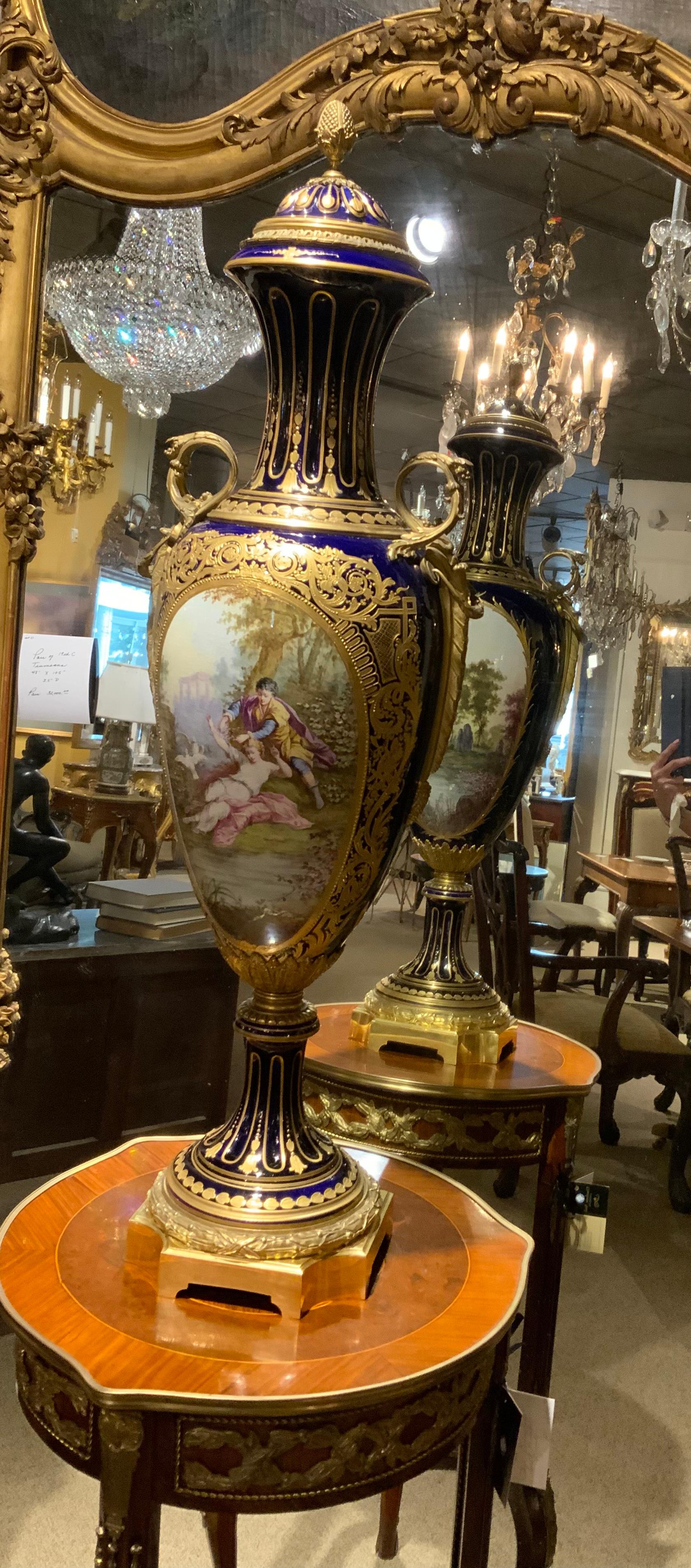 Grand and very tall urns that are extremely well painted
Make this pair exceptional.  The ormolu is original and
Complete with brilliant gilding. They are 19 th century
And signed Portevin