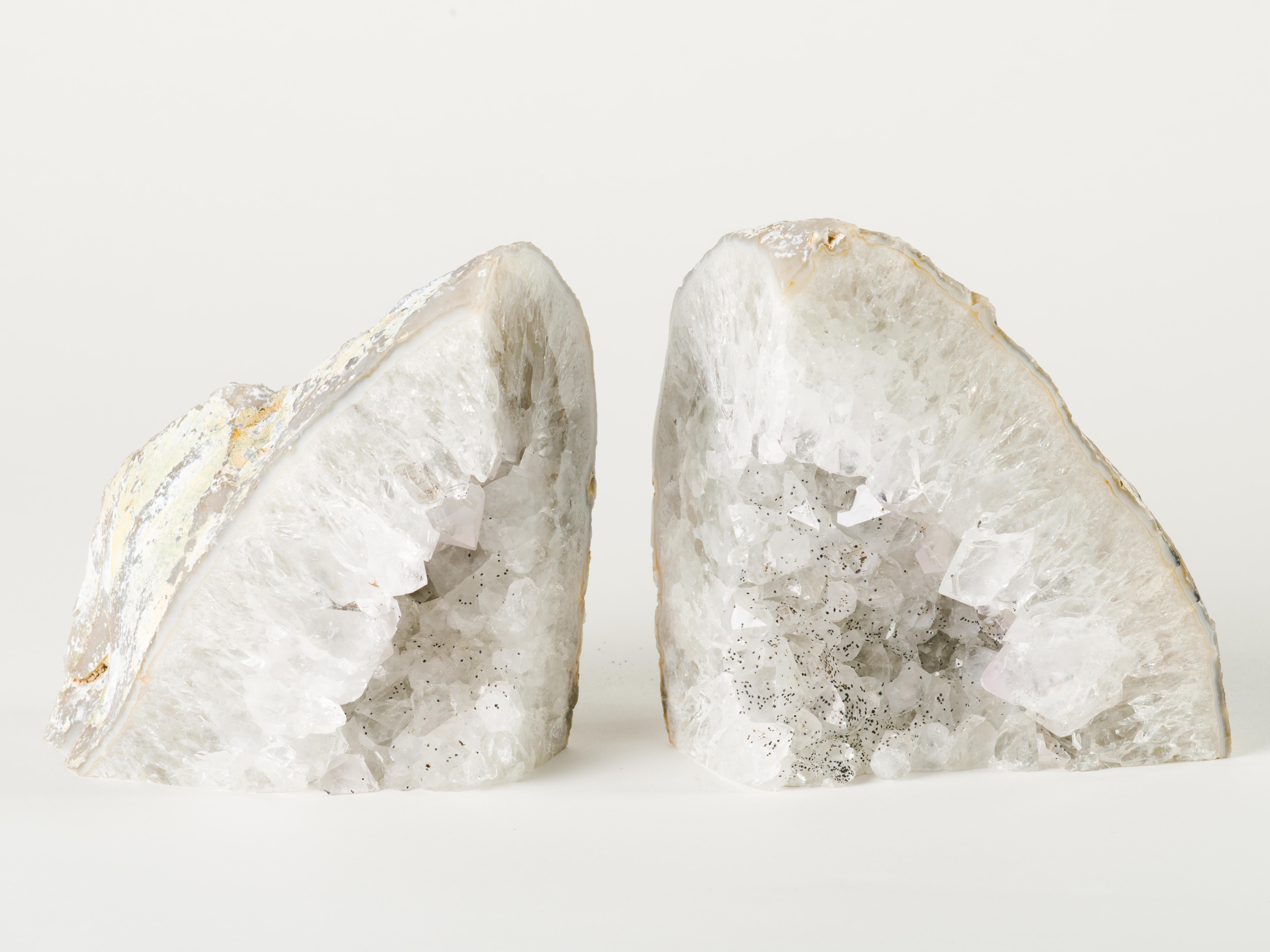 Pair of natural quartz crystal specimens with polished fronts and gorgeous rock crystal centres. The bookends have varying hues of white and silver and feature unusual speckles in gunmetal or black. Stunning from all angles and completely different