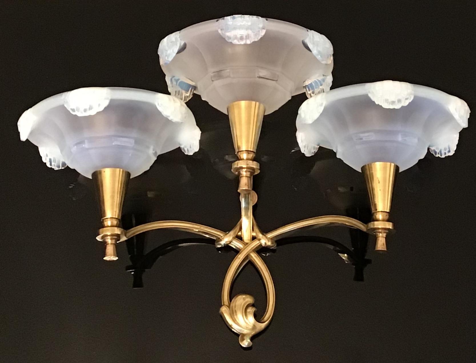 A large pair of french wall sconces in the manner of Jules Leleu.
This light fixtures are made of solid stamped bronze with six opalescent glass shades for each  3 x B22 (french bajonnett) bulbs.
Newly rewired.