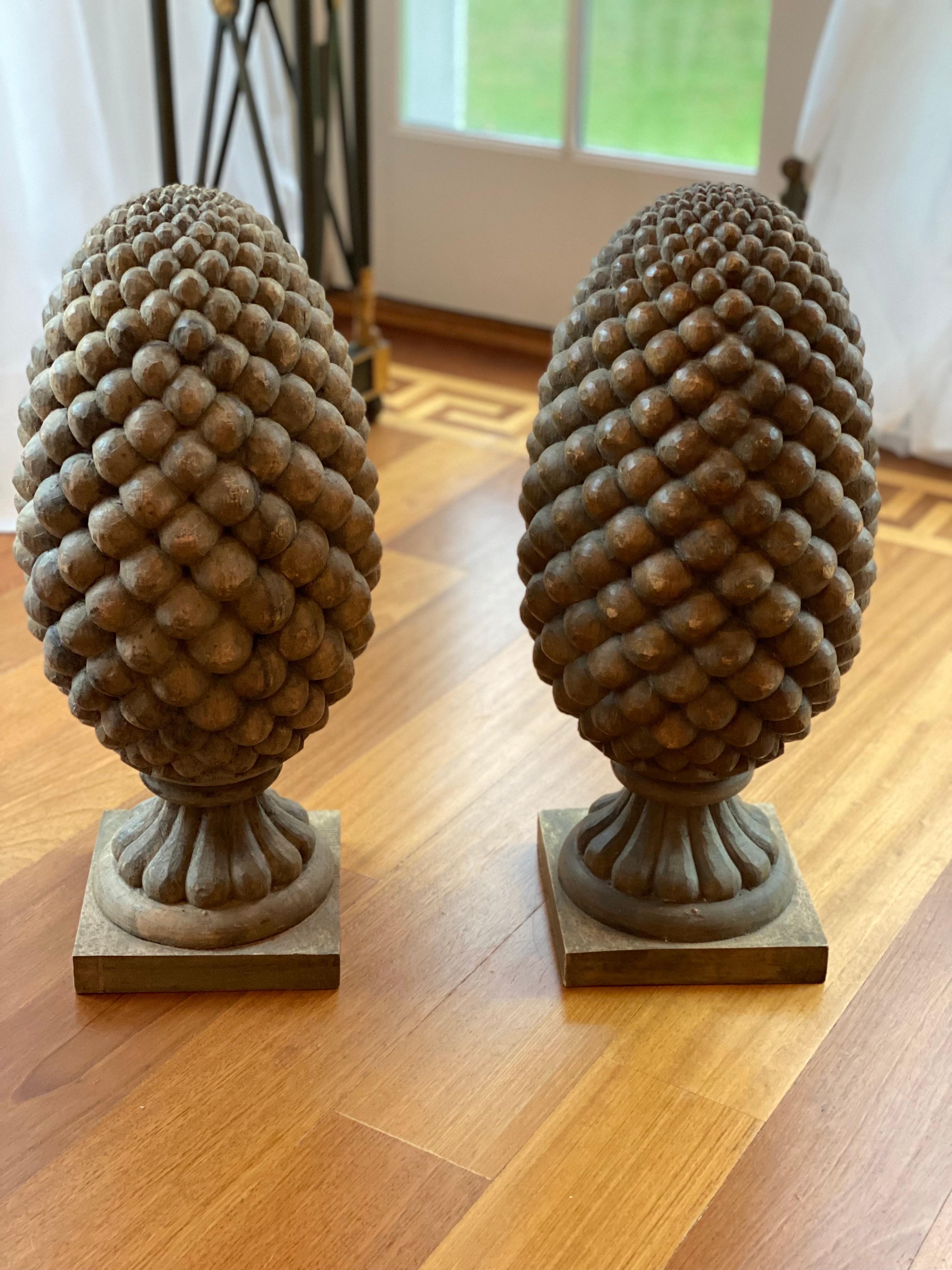 Pair of large solid hand-carved wood pinecone finials, 20th century.
A handsomepair of solid wood hand-carved finials in the shape of a pinecones.
Measures: 10” wide x 10” deep x 23” high.
Some slight separation. Good overall