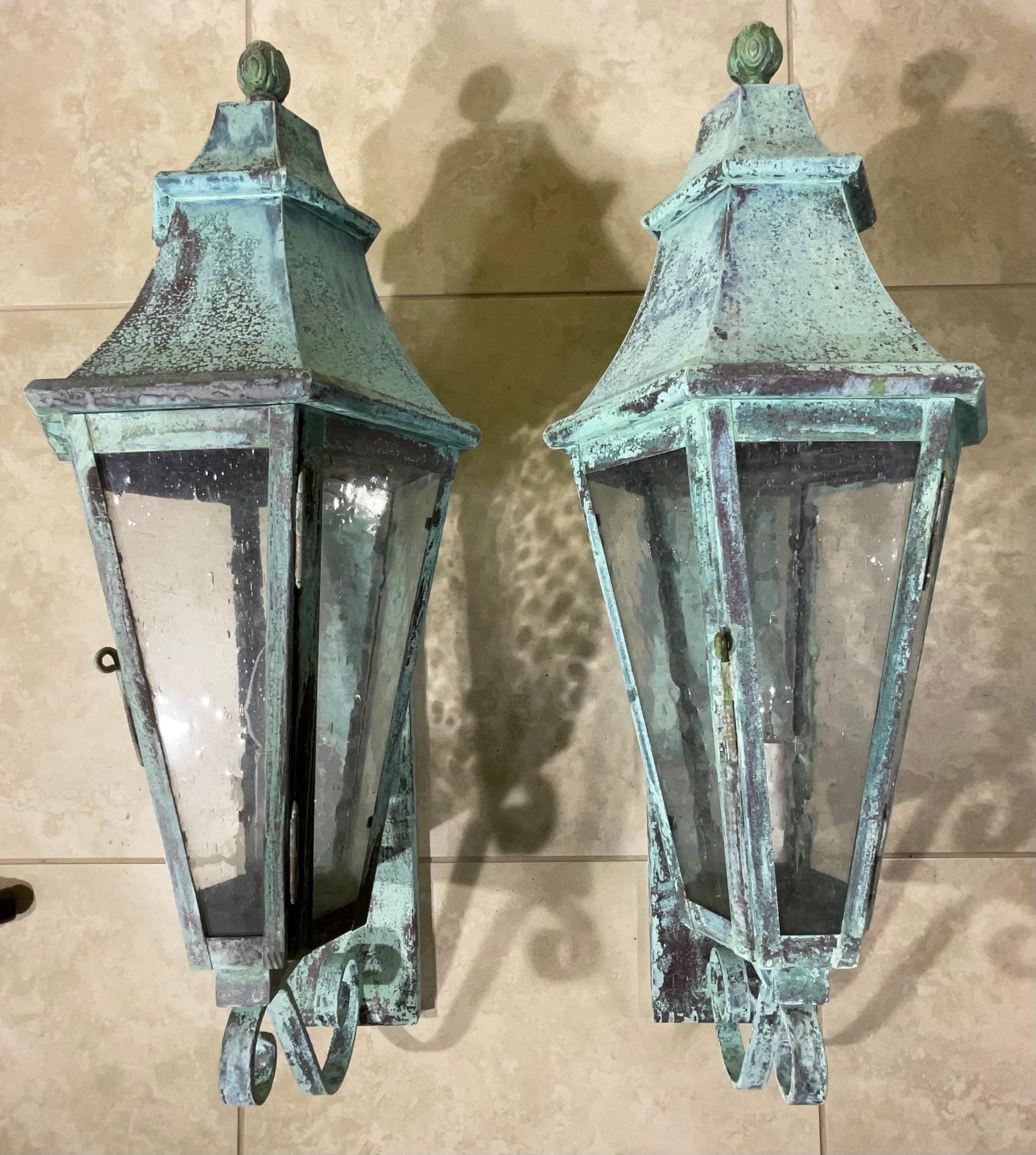 Elegant  Pair of vintage wall lantern, seeded texture glass, made of solid copper beautiful patina, one 60/watt  light each lantern, suitable for wet location,
Decorative pair.
Backplate size 19” x 4”.5