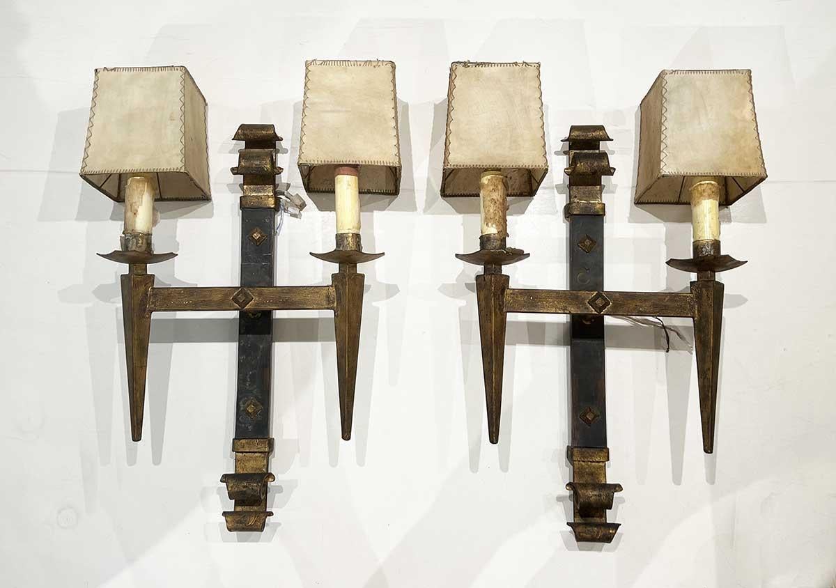 These exquisite Spanish wall sconces are a testament to the artistry and craftsmanship of traditional Spanish metalwork. Each sconce is meticulously crafted from durable iron and features a beautiful gilded finish, adding a touch of opulence and