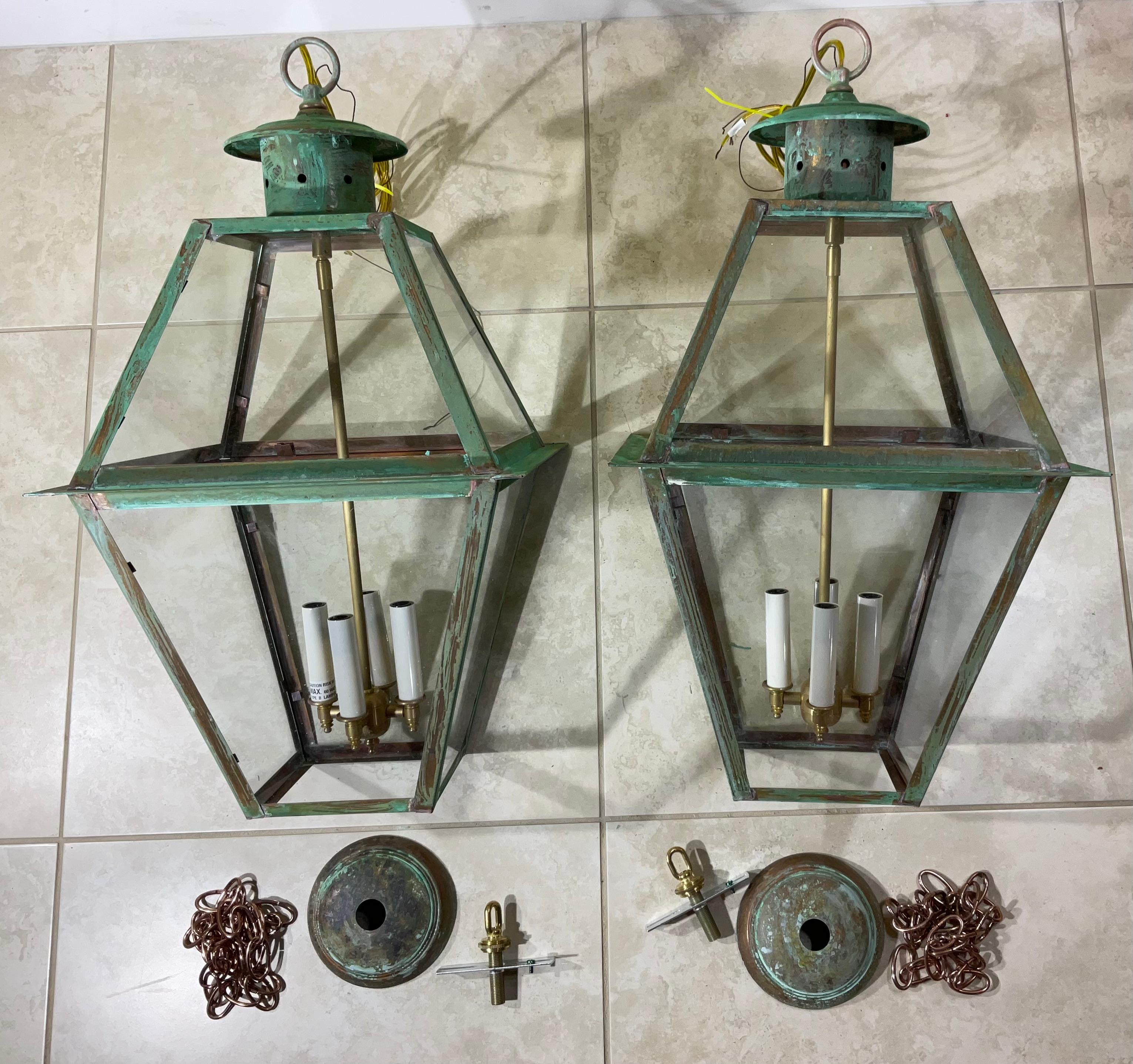 Exceptional four sides hanging pair of lanterns made of handcrafted solid copper and brass stem with four 60/watt lights, beautiful patina ,suitable for wet location Made in the US ,up to US code UL approved  ,great look indoor or outdoor.  canopy