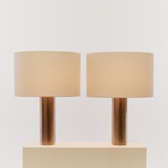 Pair of postmodern large steel cylinder table lamps, with new linen shades