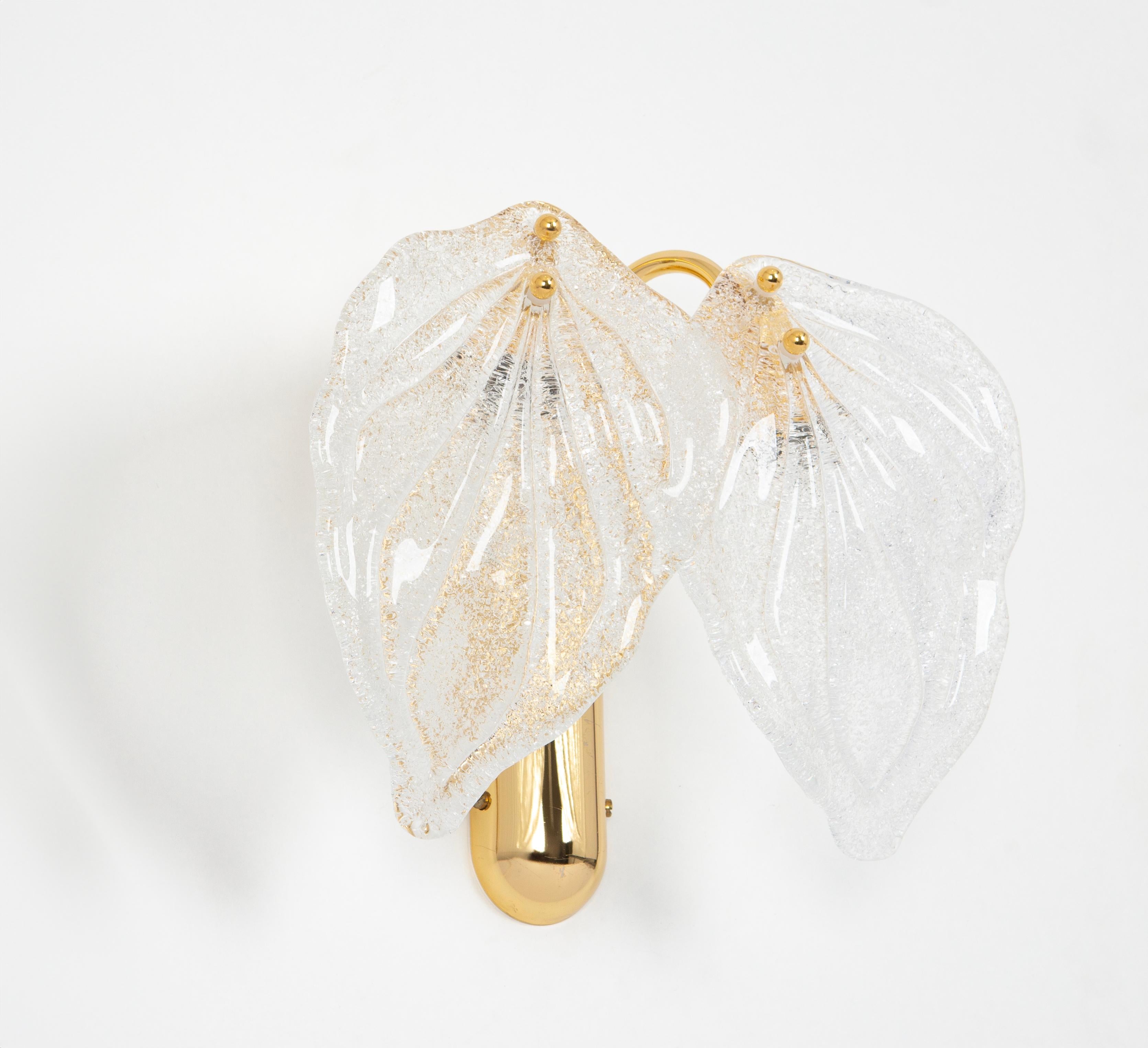 Gorgeous handblown glass leaf sconces from the manufactory Novaresi, Italy, each with two large leaves, 24-karat gold-plated frame.
High quality and in very good condition. Cleaned, well-wired and ready to use. 

The fixture requires 2 x E14
