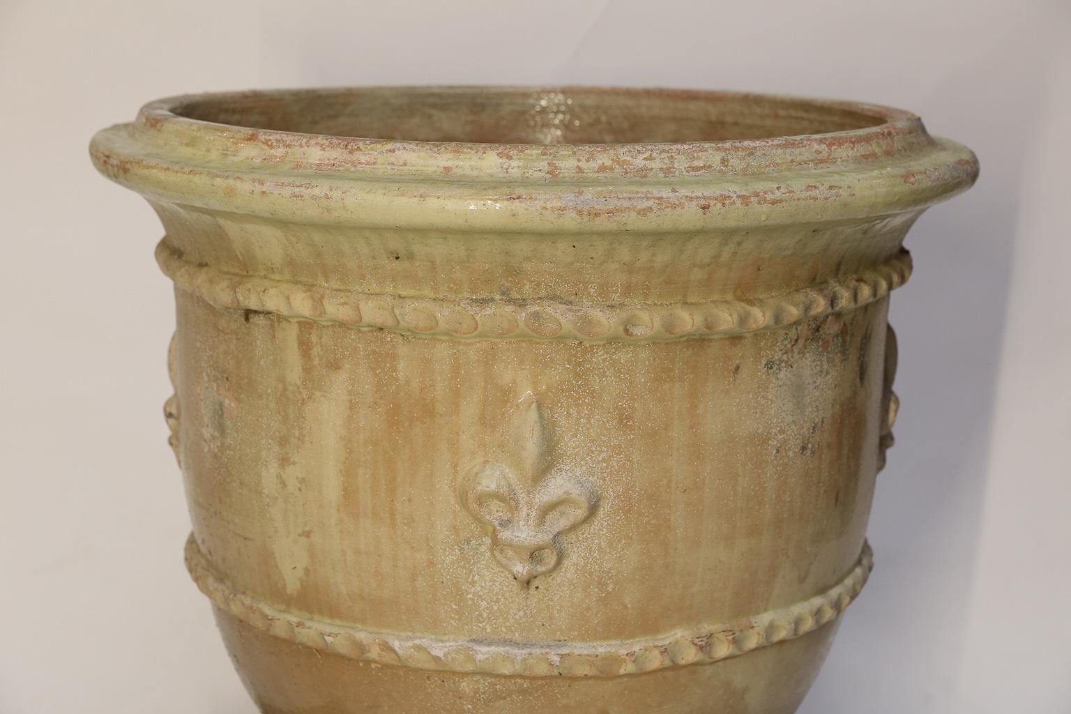 Pair of large sun faded and aged Anduze from Provence that feature raised fleur de lys between two beaded bands.