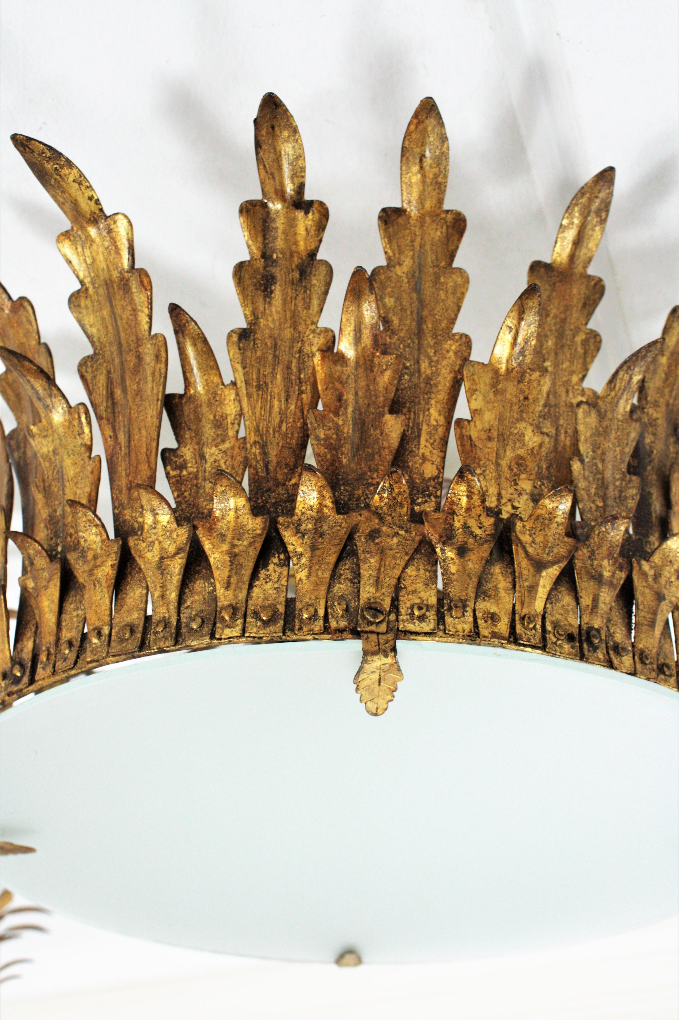 20th Century Pair of Large Sunburst Crown Flushmount Chandeliers in Wrought Gilt Iron For Sale