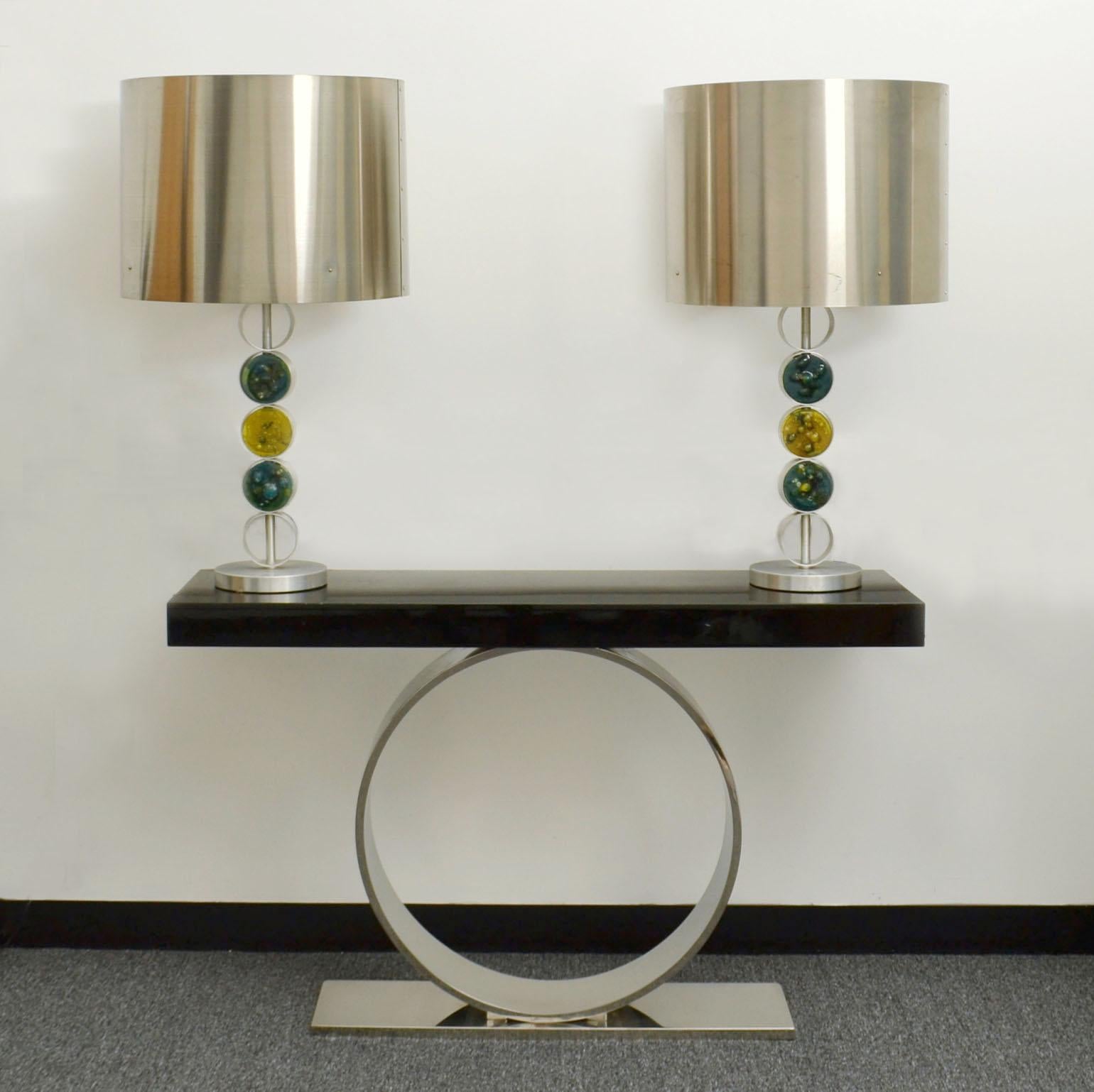 The RAAK table lamps are large, modern and of a simple design executed in aluminum, stainless steel and handmade glass, 1972 in The Netherlands. These lamps are attributed to the designer Nanny Still, one of the most famous designers at the