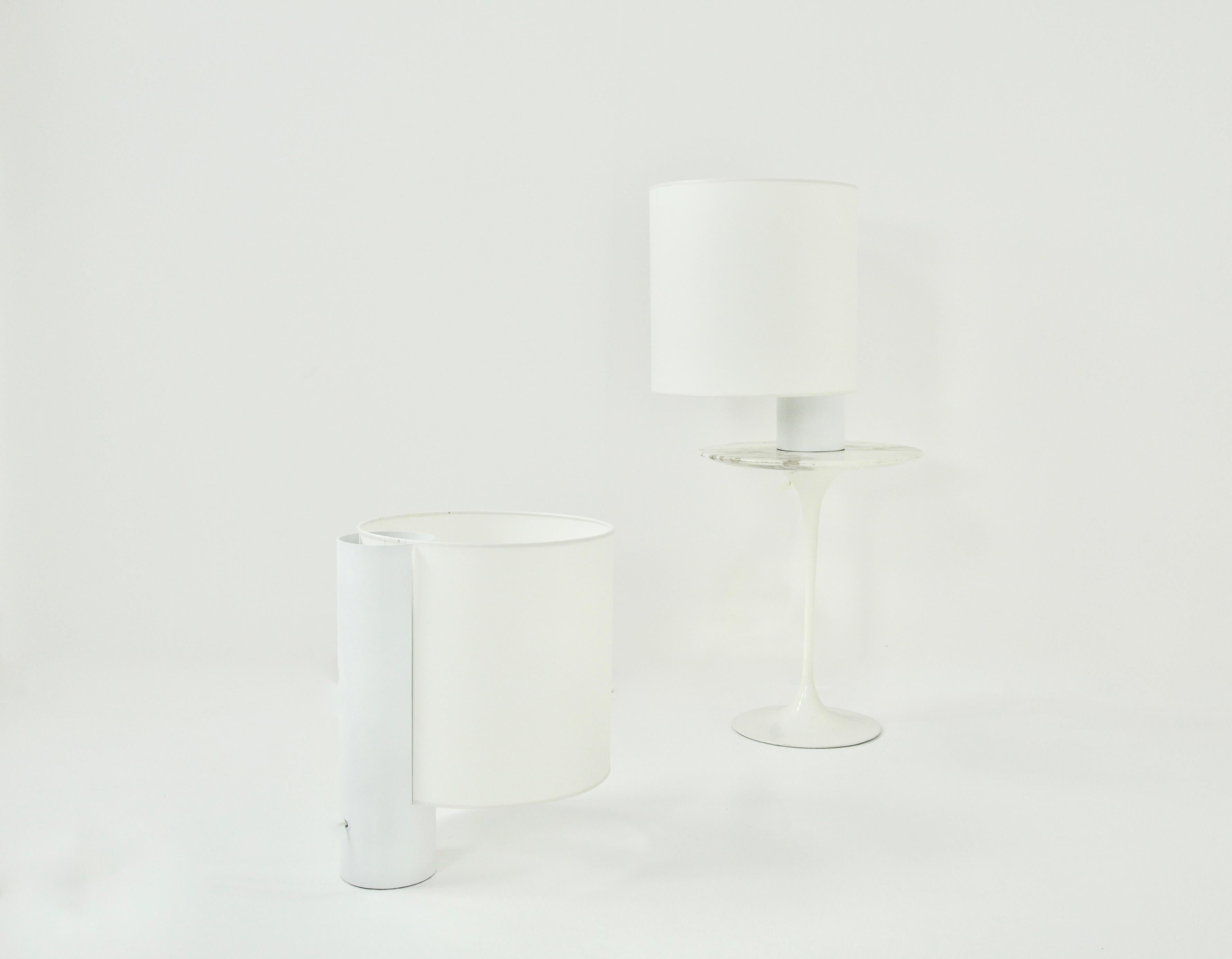 Pair of large white lamps with metal base and fabric shade. Possibility to light only the bottom or the top or even both sides of the lamp. Wear due to time and age of the lamps, (1970s).