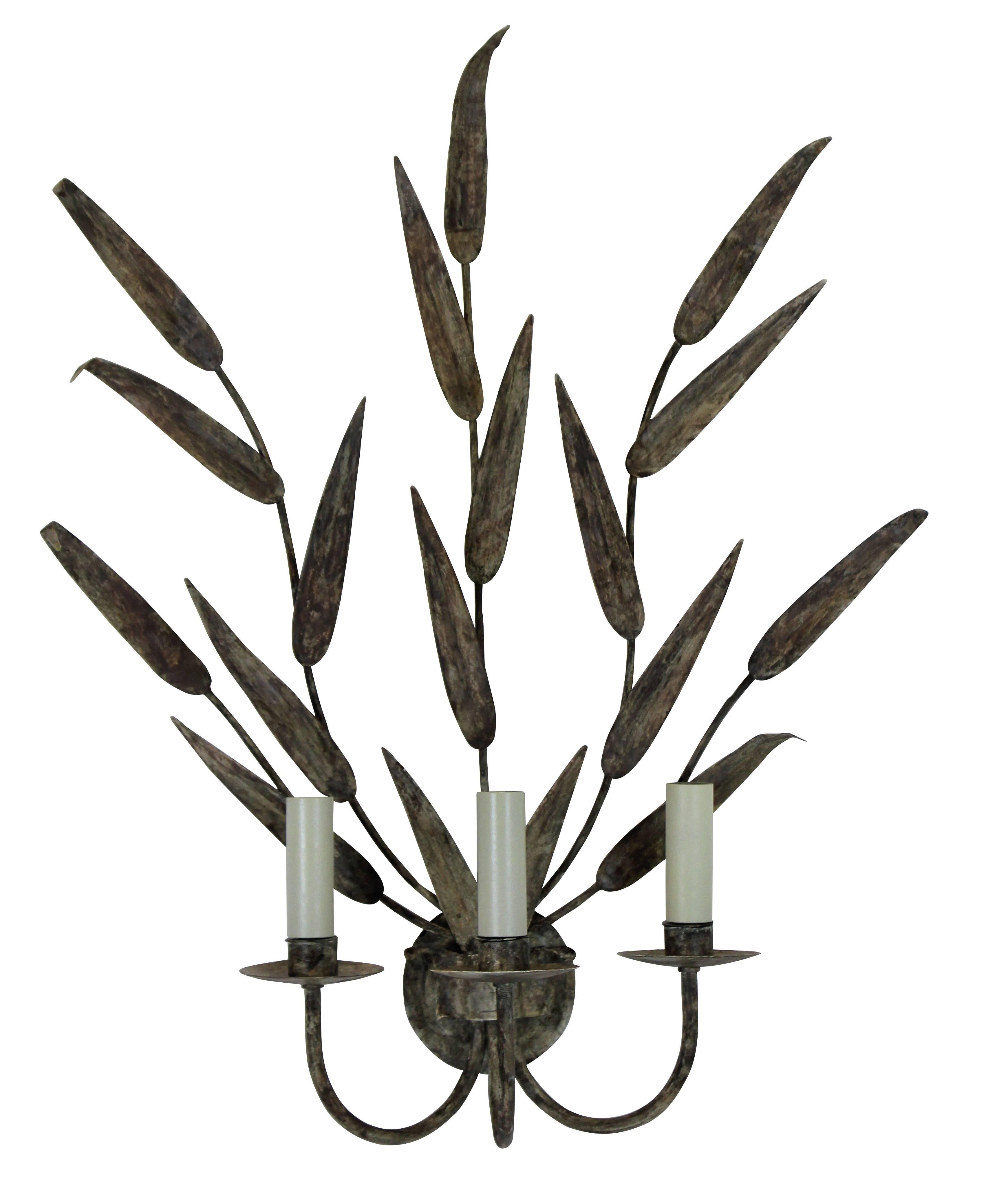 A pair of large French painted tole ware wall sconces in the form of leaves. Each with three lights.
   