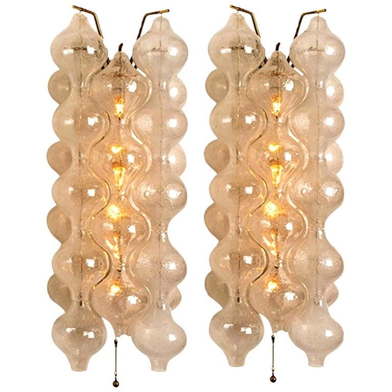 1 of the 8 unique large and elegant 'Tulipan' glass wall sconces by J.T. Kalmar, Austria, Vienna, manufactured in mid Century, circa 1970 (late 1960s or-early 1970s). Tulip shaped hand blown bubble glasses. With a white enameled metal frame which