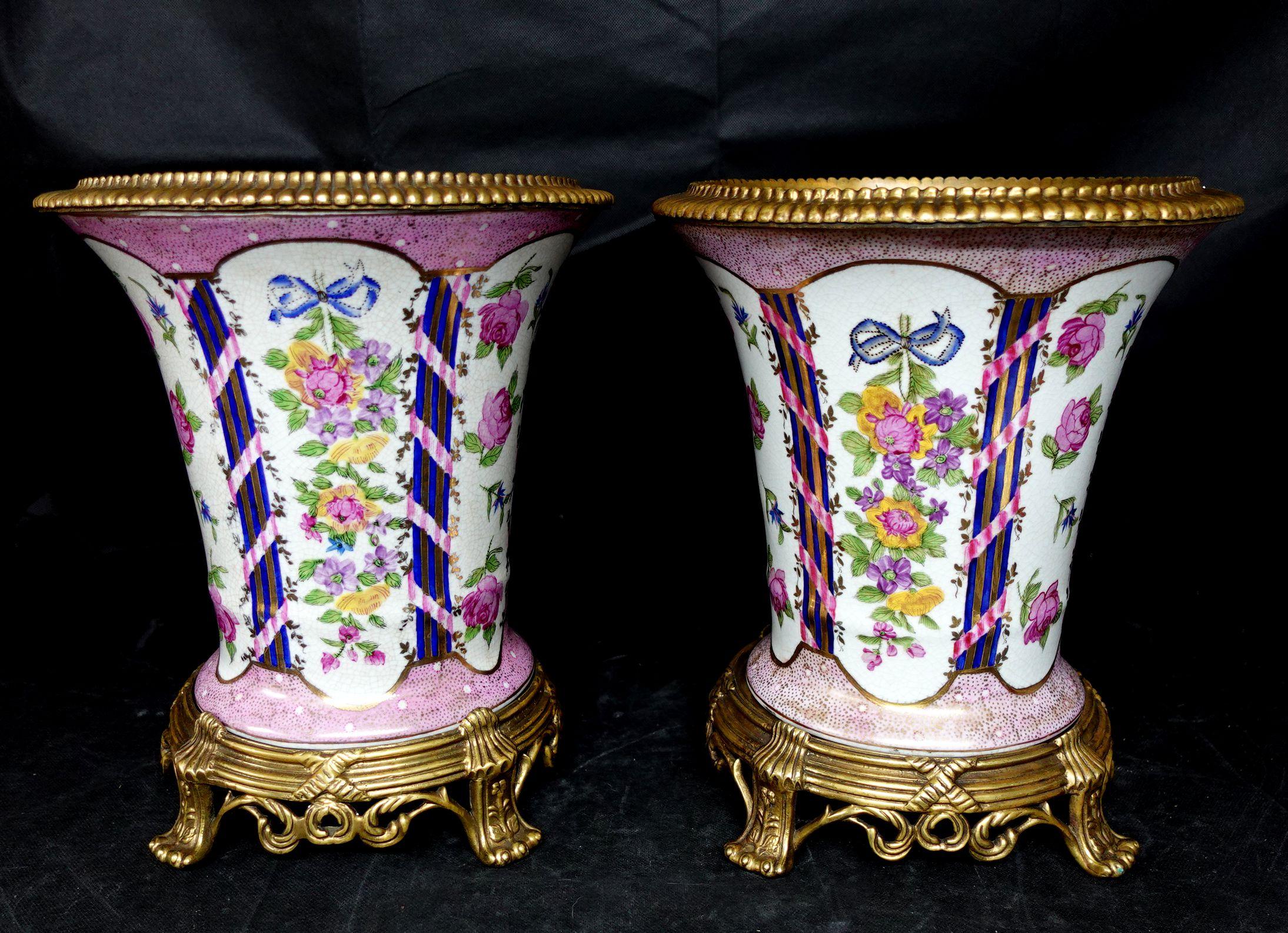Pair of Porcelain Urns, having bronze rim and foot, 20th century, Oriental seal mark on the bottoms, height 12 1/2 inches.
 Ric071.