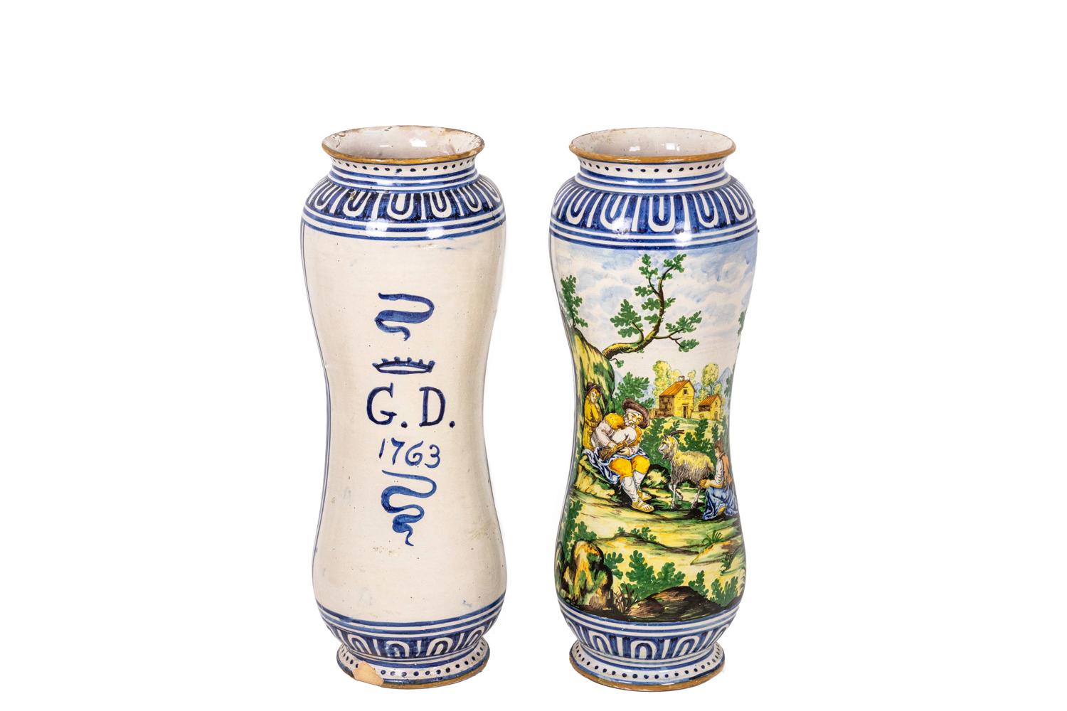 Pair of large vases in polychrome earthenware in the style of Italian Maiolica from the 16th century. Decor of pastoral scenes : one with a couple of sheperds surrounded by their sheeps on a background with green mountains and a village; the other