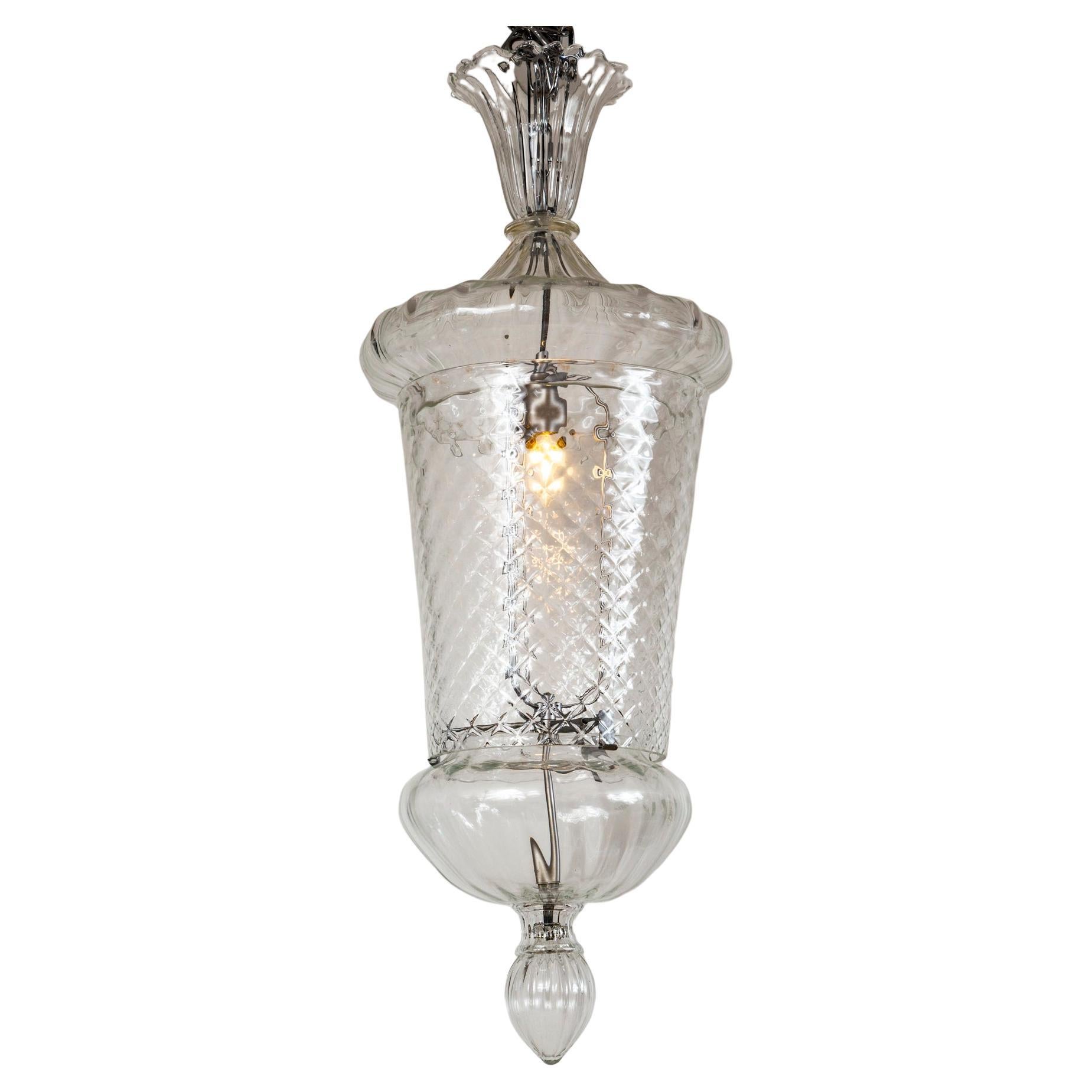 A very beautiful pair of large crystal clear Venetian  lanterns composed of six seperately blown pieces.  Tapered cylindrical body blown in a textured diamond shaped pattern.

Dating: Old Stock 1970ca

Origin: Murano, Italy

Condition:
