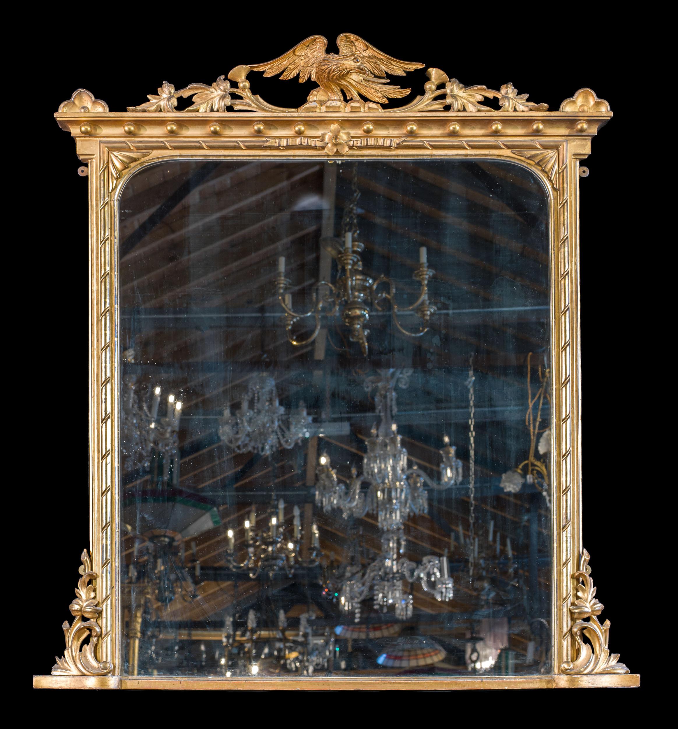 A large and grand pair of gilt gesso Victorian overmantel mirrors. The slender spiral fluted frames are surmounted by eagles on rocky outcrops, situated within a thistle decoration.
Provenance: Runnymede Park, Surrey.

English, circa 1850.