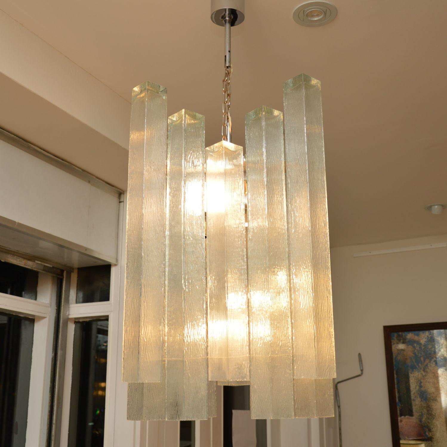 A stunning pair of vintage glass and chrome chandeliers, these were made in Germany in the 1960s by Doria Leuchten. They are of fabulous quality, they’re very large and impressive. These came straight out of the London home of a very famous