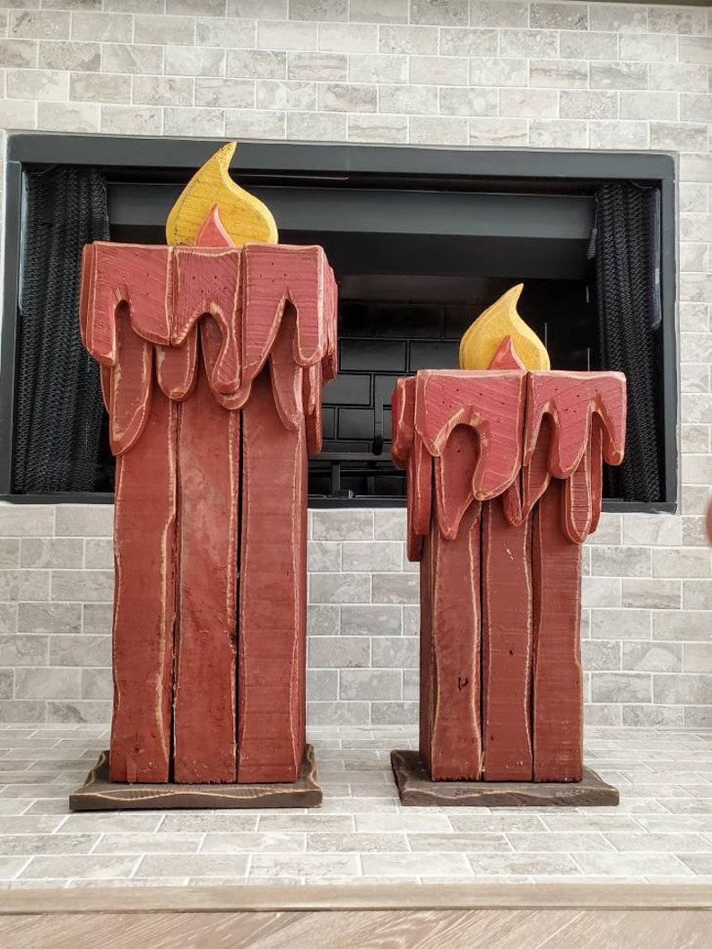 Add unique decorative character, elegant charm, and warm, whimsical Holliday fun with this one of a kind pair of vintage American folk art sculptural painted red slatted wood Christmas candle decoration.

These large, fanciful statues are the