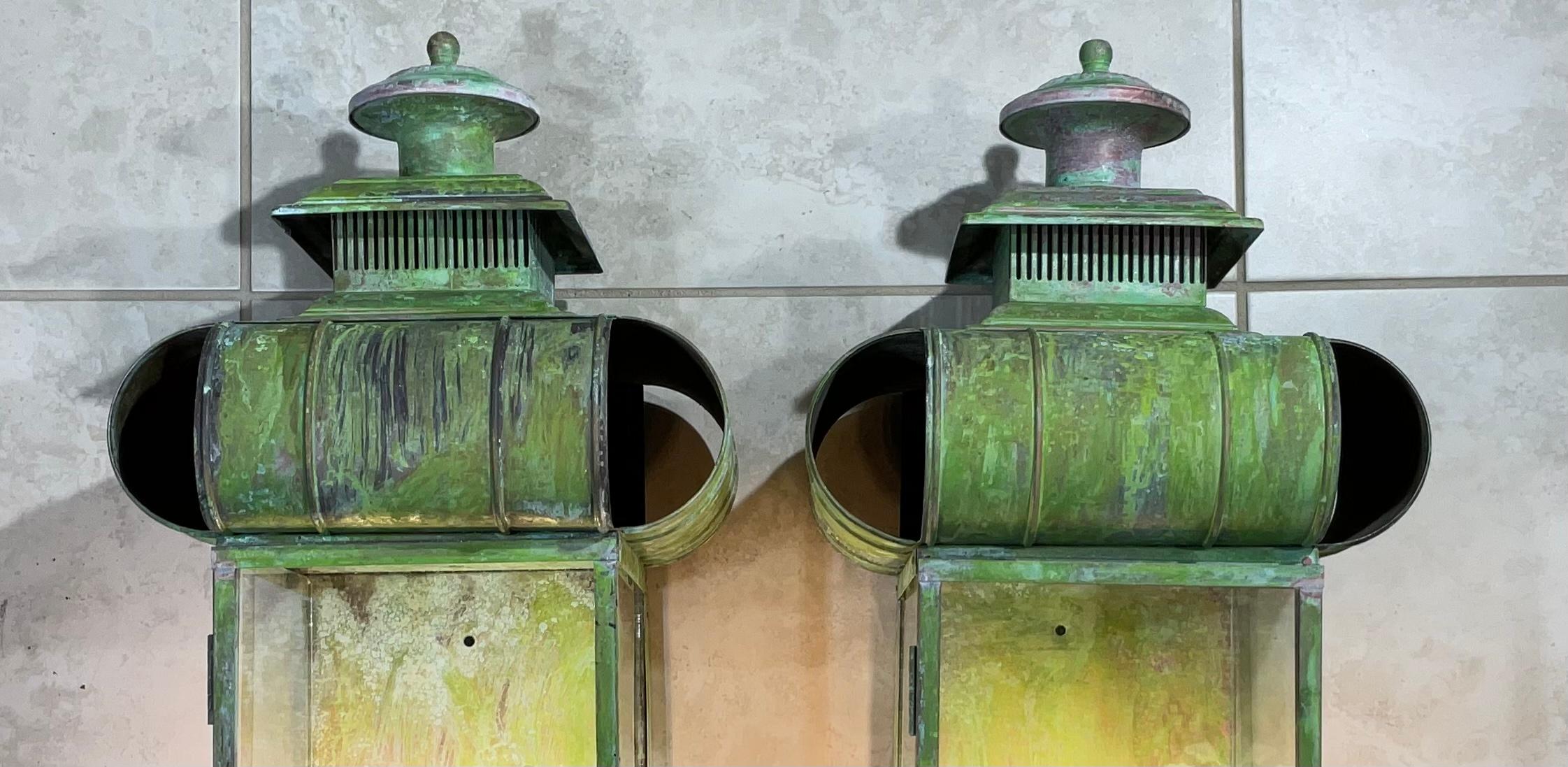 Pair of wall lantern or wall sconces, made of solid copper, beautiful patina, two 60/watt lights each lantern,
Suitable for wet locations, 
Great looking wall lanterns for any entrance.