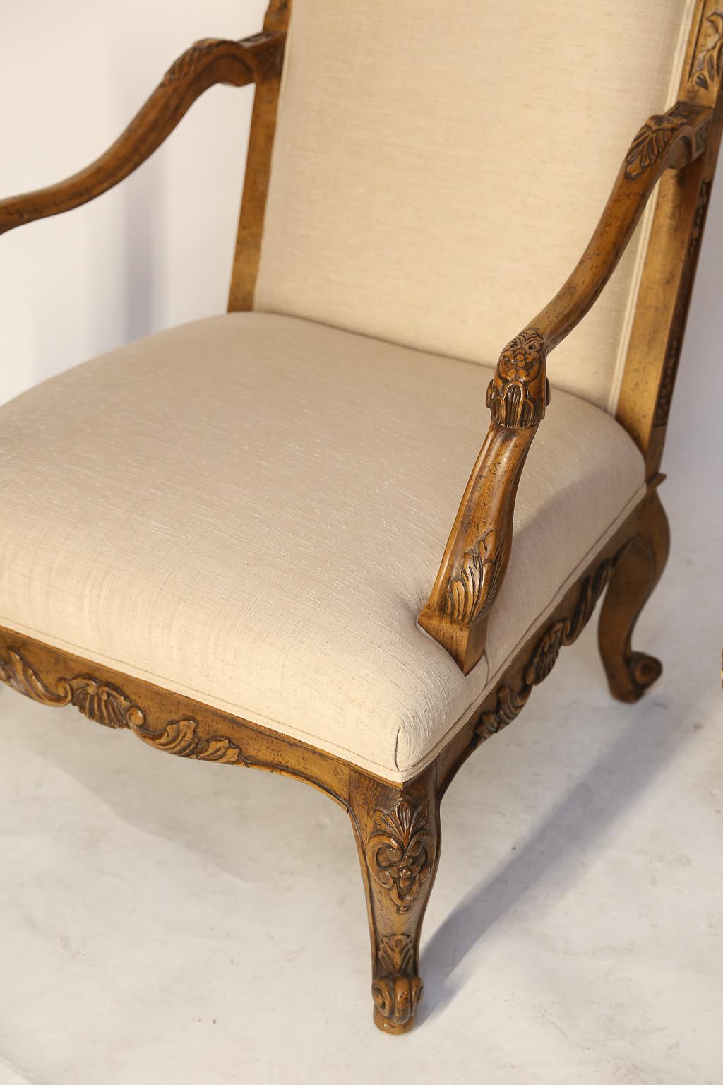 Pair of vintage Baker Furniture French Regence-style fauteuil chairs, from Spain, have a fruitwood finish, done in Grand Rapids, Michigan. 
The shape is very unusual and the finish is quite rich, plus they are extremely comfortable due to the pitch