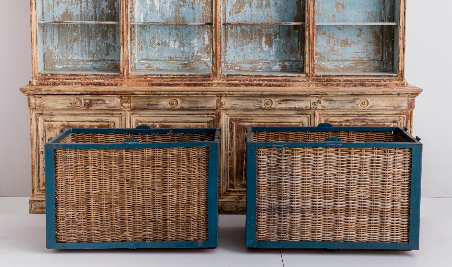 Pair of large, industrial French wicker baskets from a wool mill painted steel frames featuring original blue paint. There is some slight denting of the steel frame on one of the pieces. These baskets would work beautifully adapted into table bases