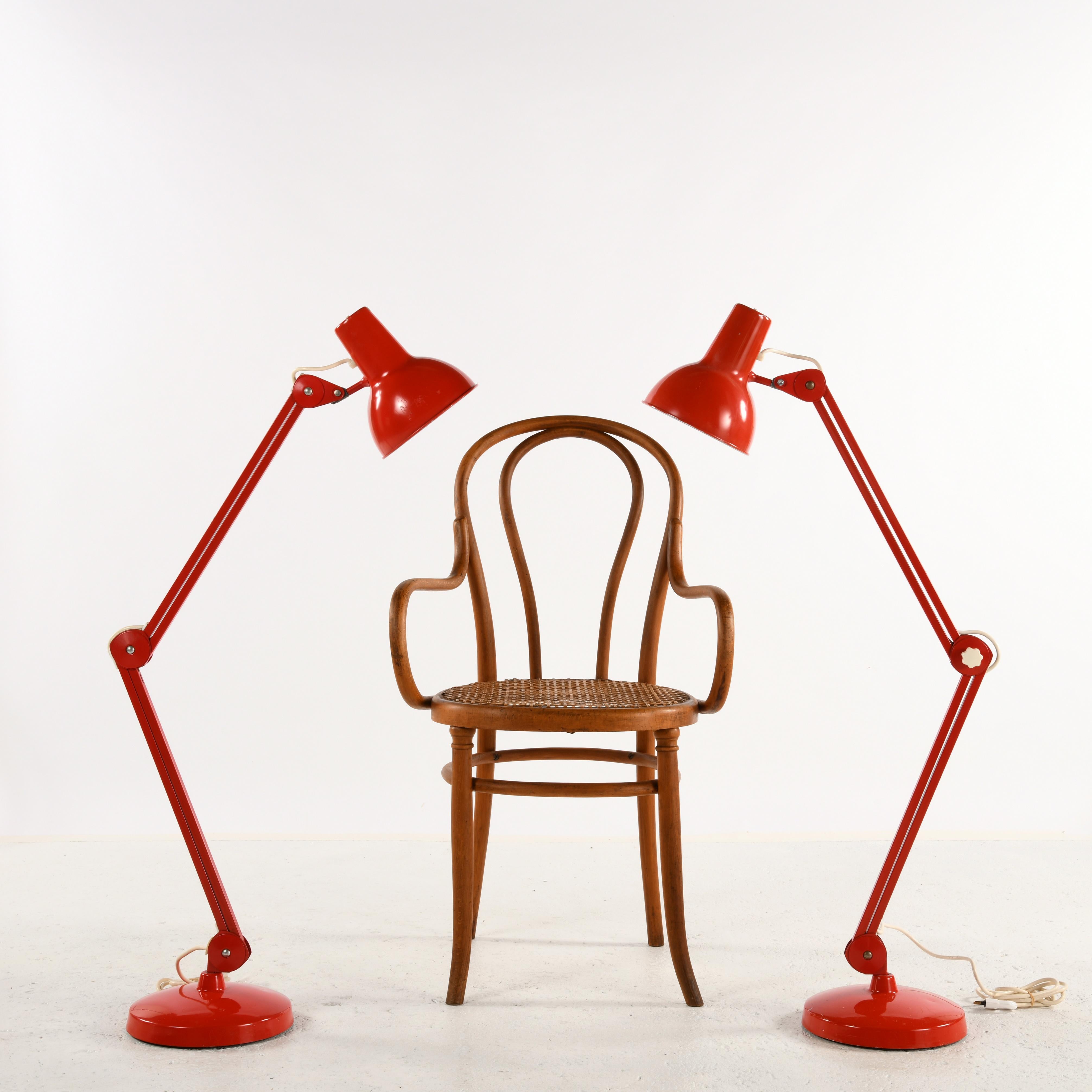 Two large articulated table lamps by LUXO (Norway) designed by Jacob Jacobsen circa 1937, 1960s/70s editions.  These lamps can be placed on a piece of furniture or a desk, or on the floor. 
The pedestals are weighted down by a steel base under which