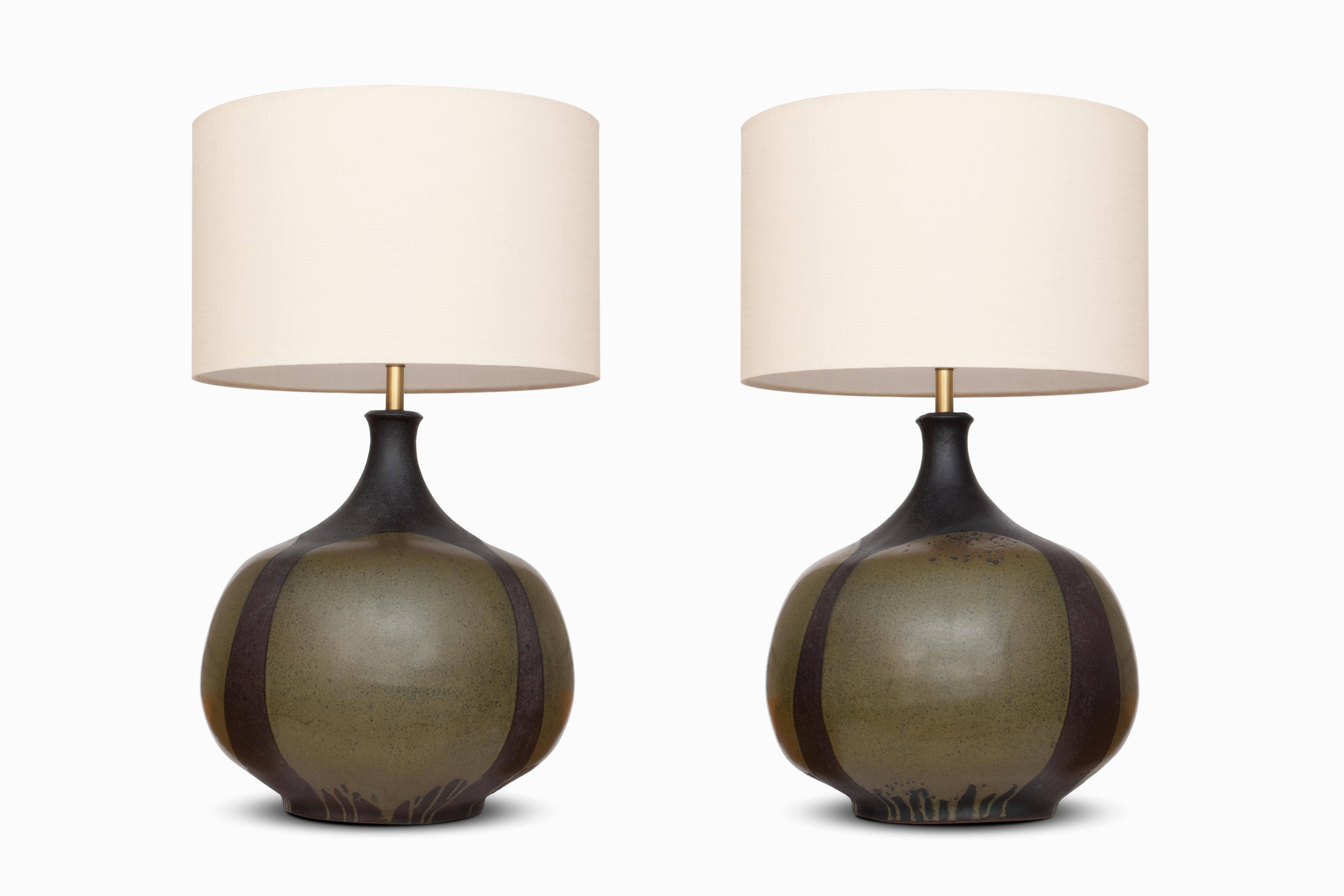 Here is a pair of monumental ceramic table lamps by beloved California potter David Cressey.  The stoneware forms feature a beautiful grey and green earth tone combination and the artist's signature drip glaze.  They measure approximately 20
