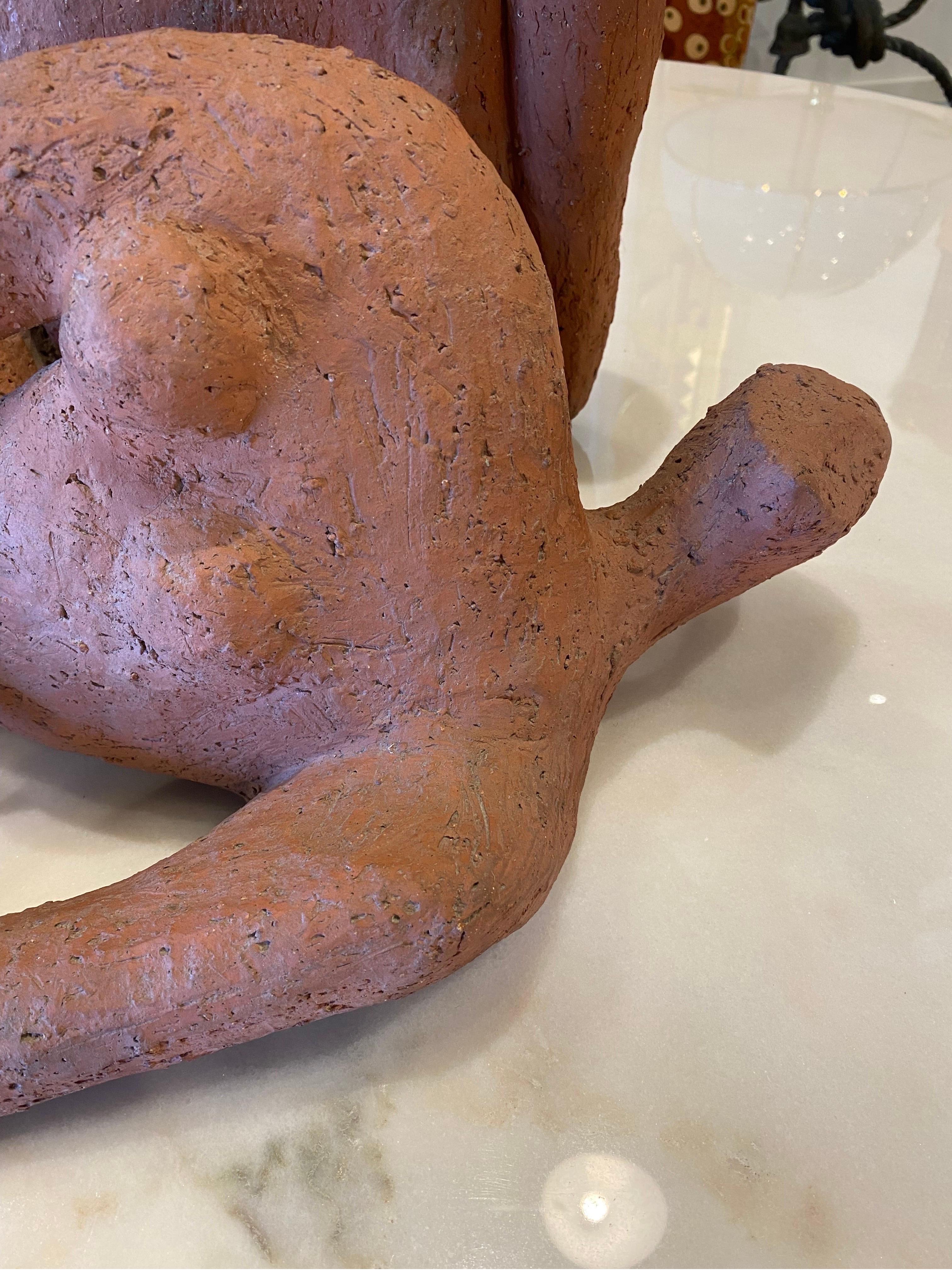 This is a very cool unsigned pair of clay nude sculptures from the 1960's that have a very good resemblance to Henry Moore's works. They are clay or terra cotta and the upright sculpture has a slightly darker red hue than the reclining one. Upright