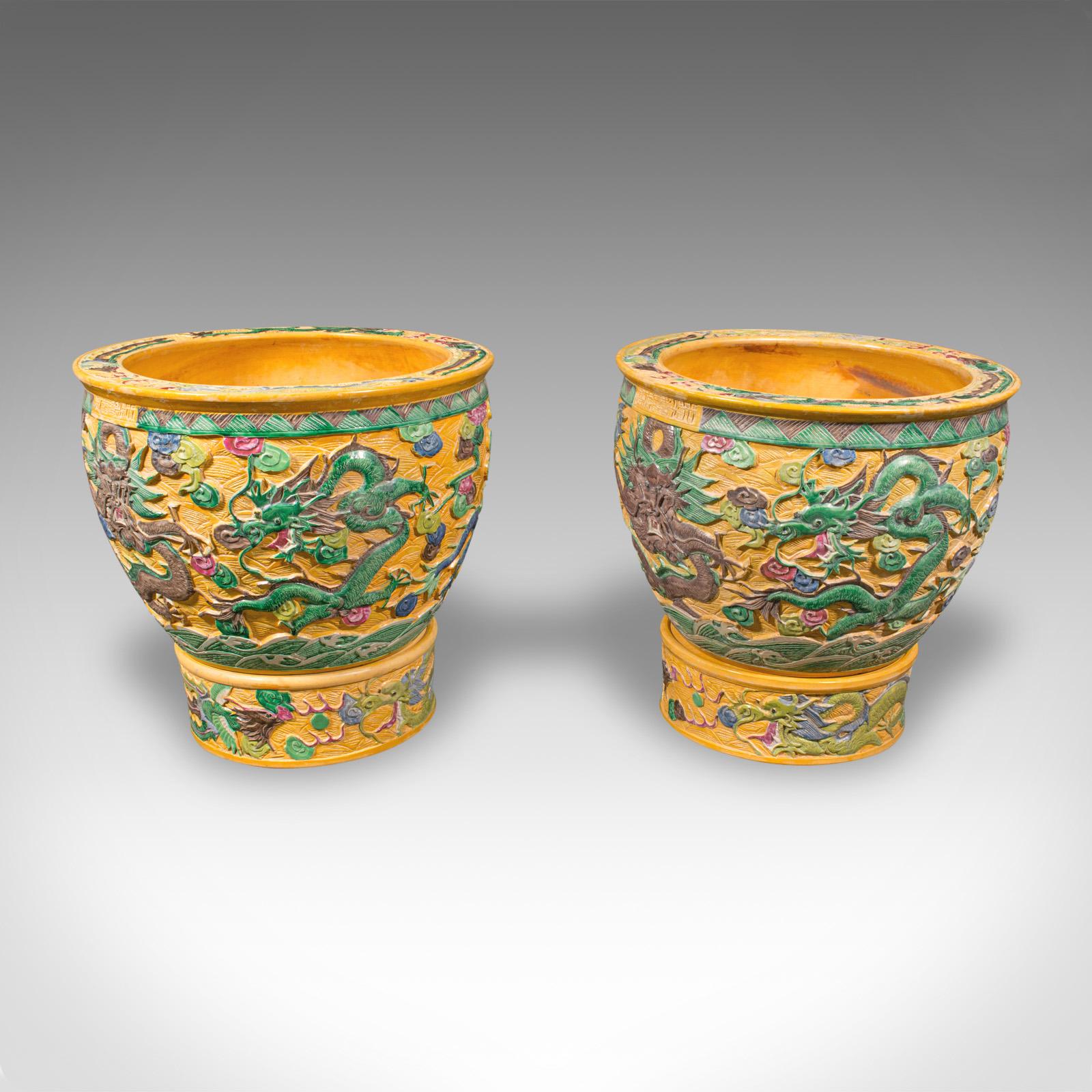 This is a pair of large vintage planters. A Chinese, relief ceramic decorative jardiniere, dating to the Art Deco period, circa 1930.

Delightfully substantial statement planters for the hall or lounge
Displaying a desirable aged patina and in good