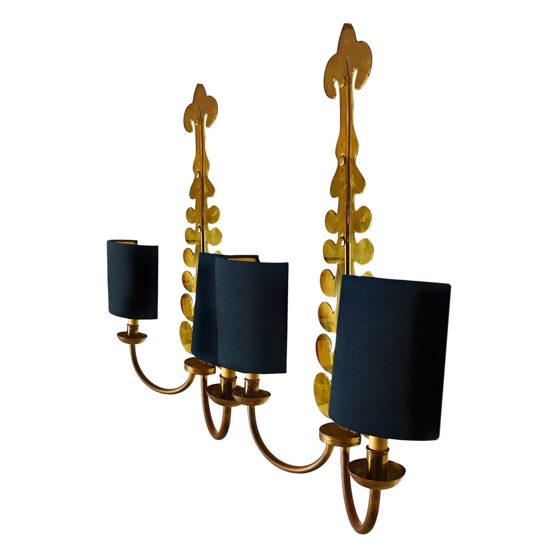 Pair of large wall lights, in polished brass with refurbished lampshades in black fabric and gold interior. ‘Candles’ supporting the original painted wooden sockets.

Casa Valenti.

Spain, Barcelona circa 1960.