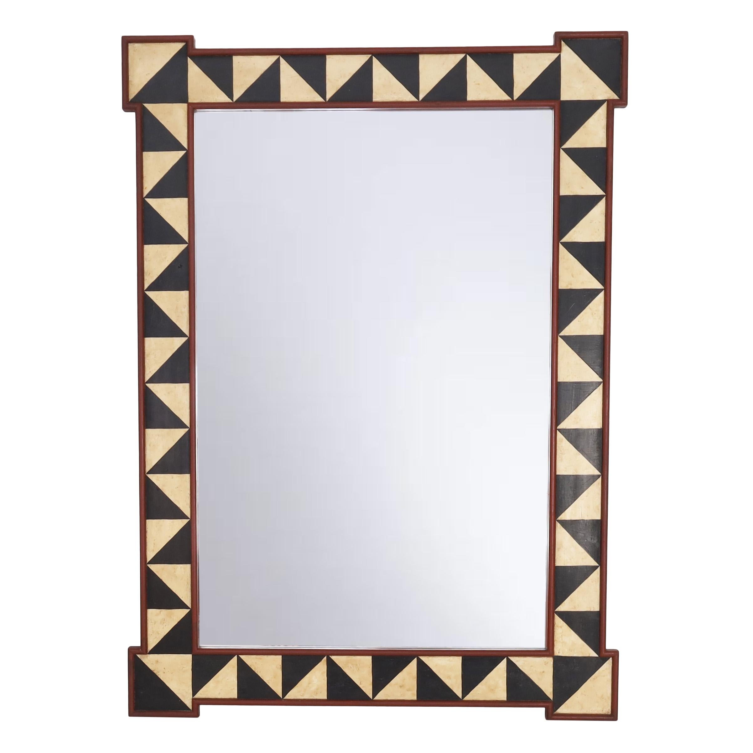 Intriguing pair of one of a kind large wall mirrors with classic form and plenty of decorative appeal, hand decorated in muted warm colors in geometric designs. Signed Jolly Irving 2006 in the lower right. 