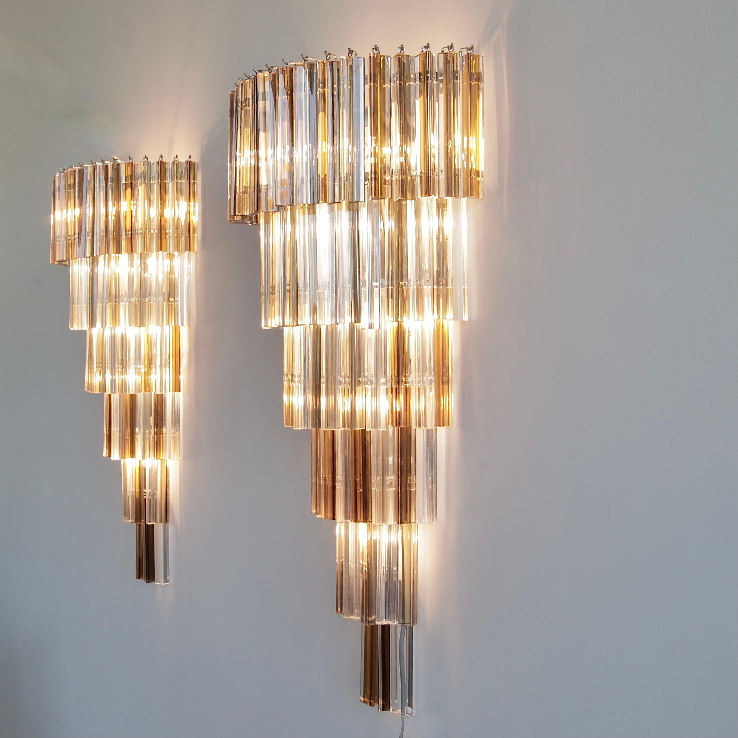 Pair of wall sconces. Italy, Murano, 1980a.

A very large pair of six-tier glass sconces with 'Trilobi' Murano glass in clear, Tabac and dark brown. Metal frames with ten E14 light fittings each.