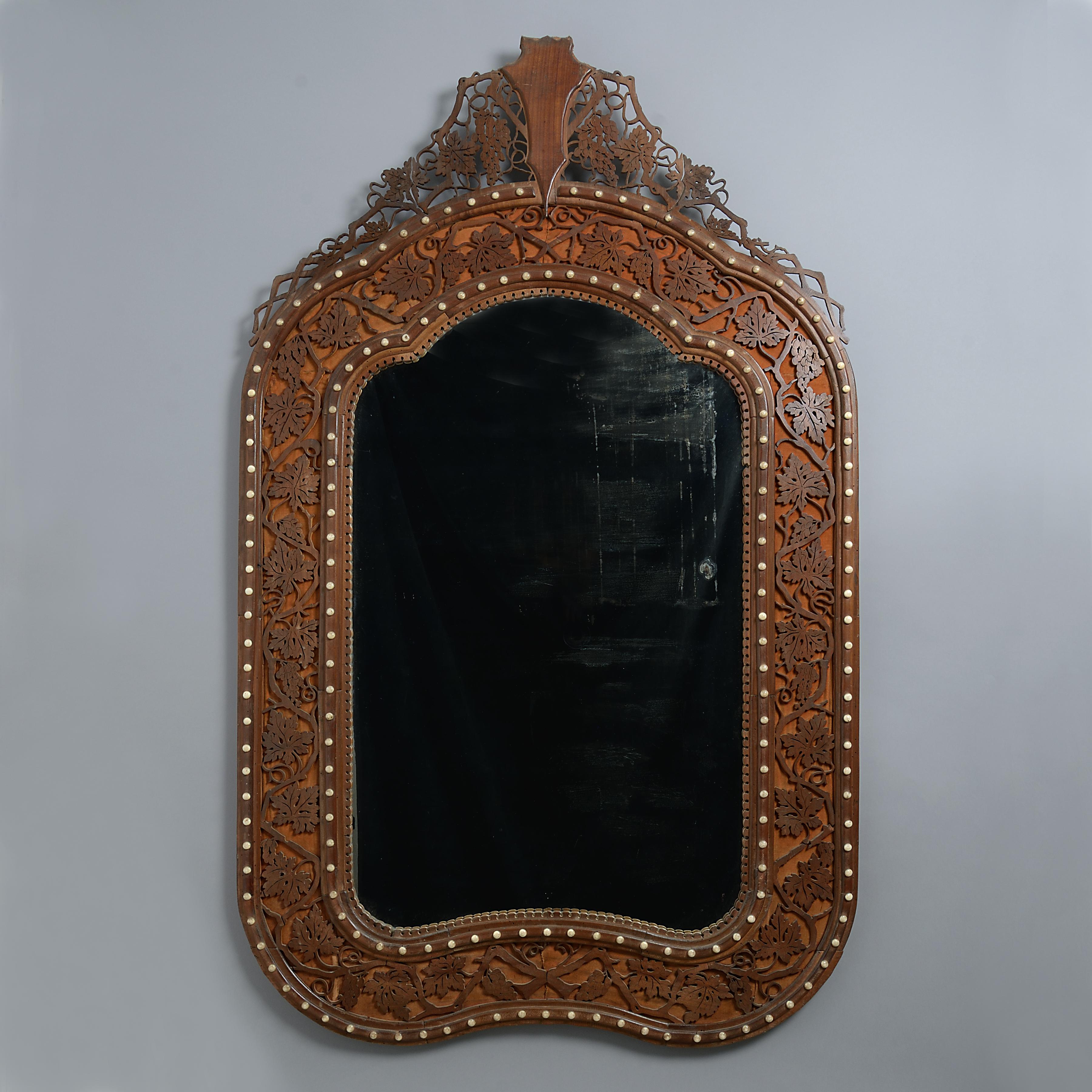 An unusual pair of large walnut mirrors decorated with bone studs, circa 1875.

Each with fruiting vine fretwork on a velvet ground.