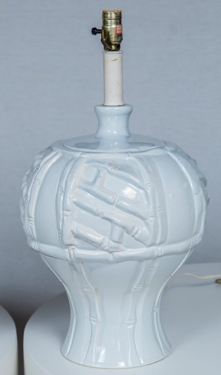 Large scale white ceramic faux bamboo pair of lamps from the 1970s.
High relief bamboo motif. Very dramatic lamps.