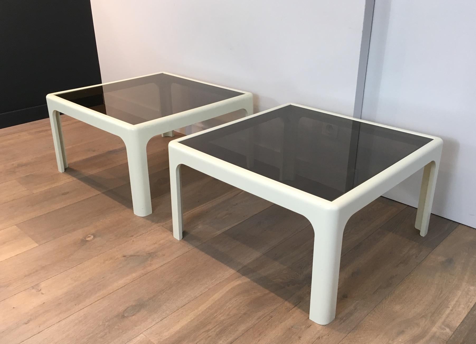 This pair of large side tables are made of white fiber glass with smoked glass shelves on top. The end tables still have their original sticker Poshinger. This is a work German, circa 1970.