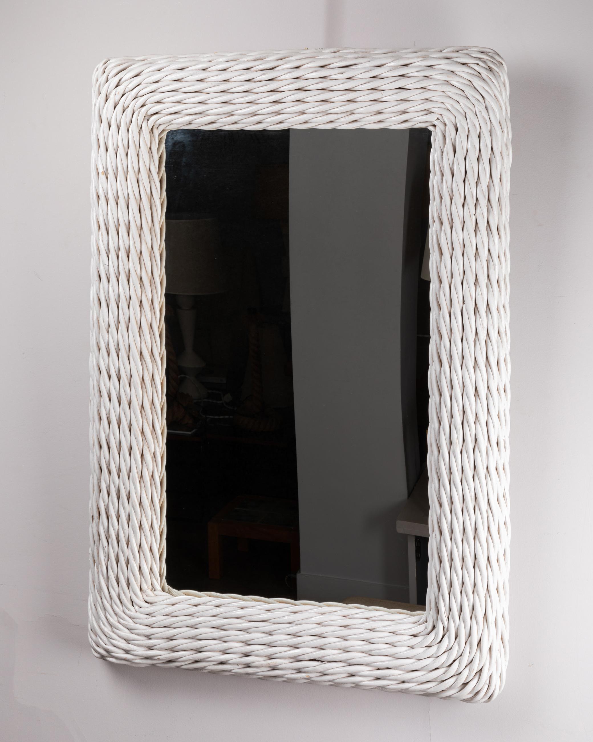 Pair of white painted braided rattan mirrors. 
The frames of the two mirrors are made of twisted strings of thick rattan. 

Italy 
1970's
Prized for the pair 

Dimensions : 

Height : 99 cm / 39,00 inch 
Width : 68 cm / 26,77 inch 
Depth : 6.5 cm /