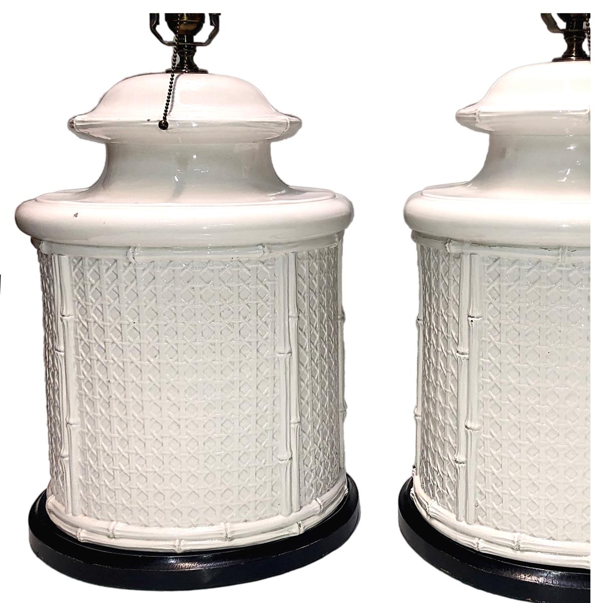 Pair of circa 1950s large French porcelain lamps in the shape of wicker and bamboo with ebonized bases.

Measurements:
Height of body 19